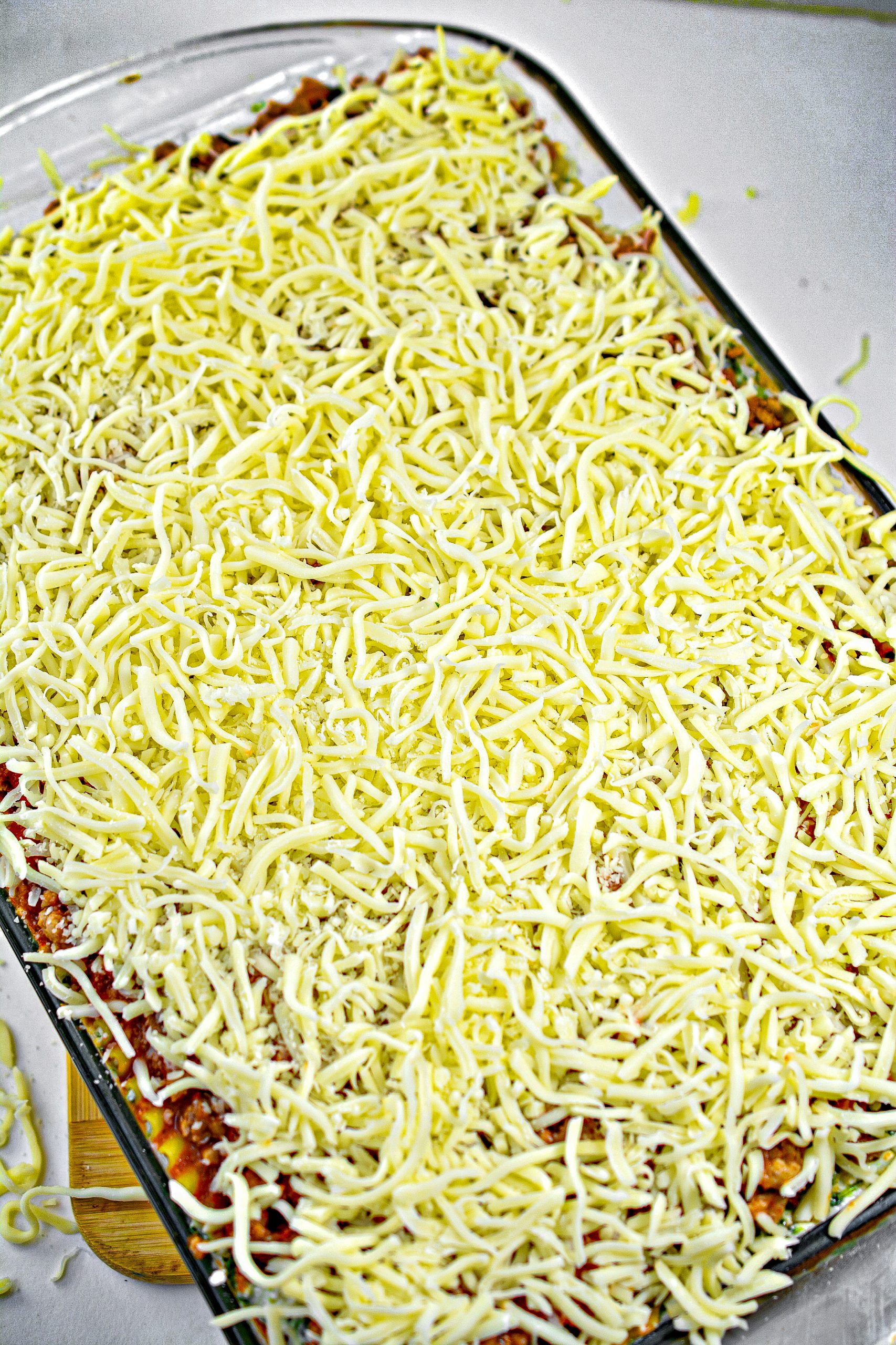Repeat with a layer of noodles, then the other ½ of the cheese mixture, 2 more cups of cheese and ⅓ of the meat mixture.
