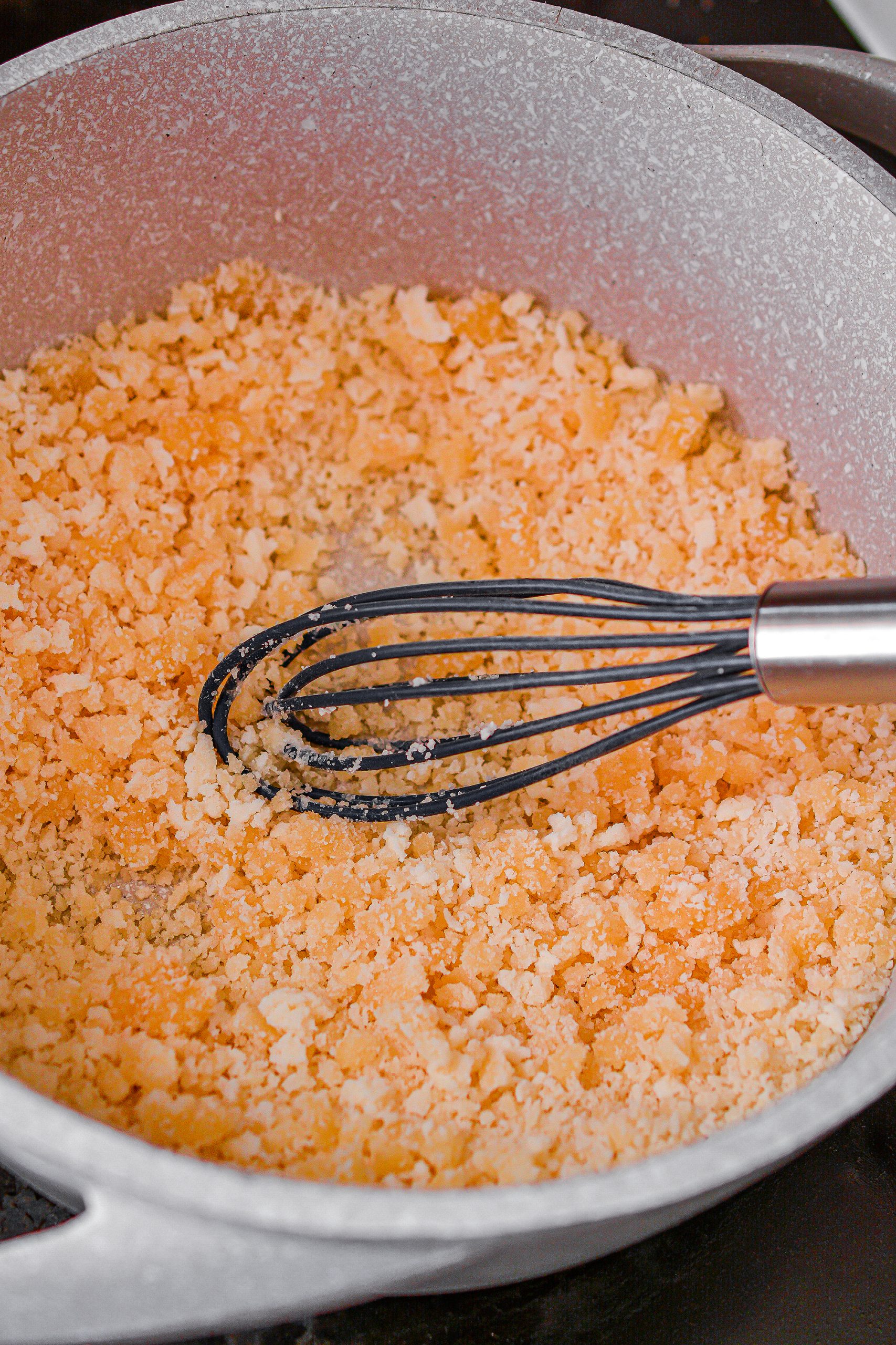 Heat the sugar in a saucepan over medium high heat on the stove while whisking often to prevent it from burning.