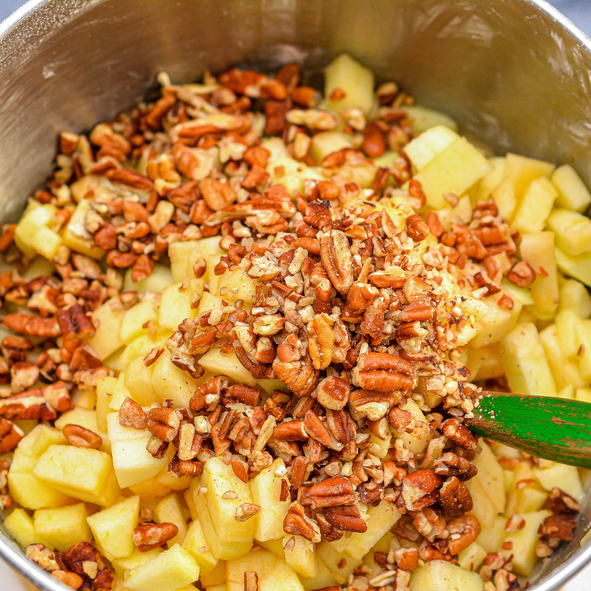 Fold the apples and pecans into the batter, and place into a well-greased bundt pan.