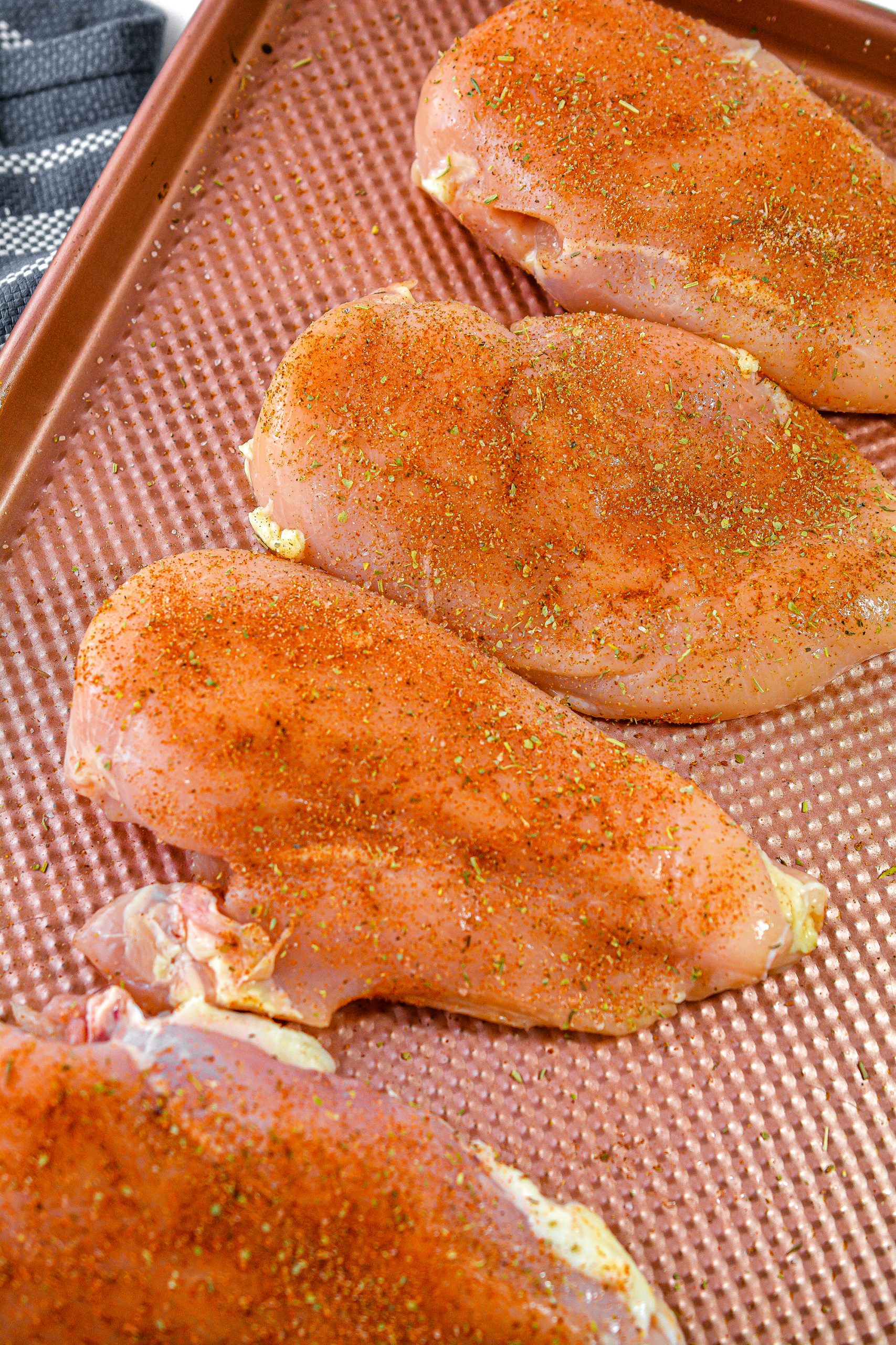 Season both sides of the chicken breasts with the spice mixture.