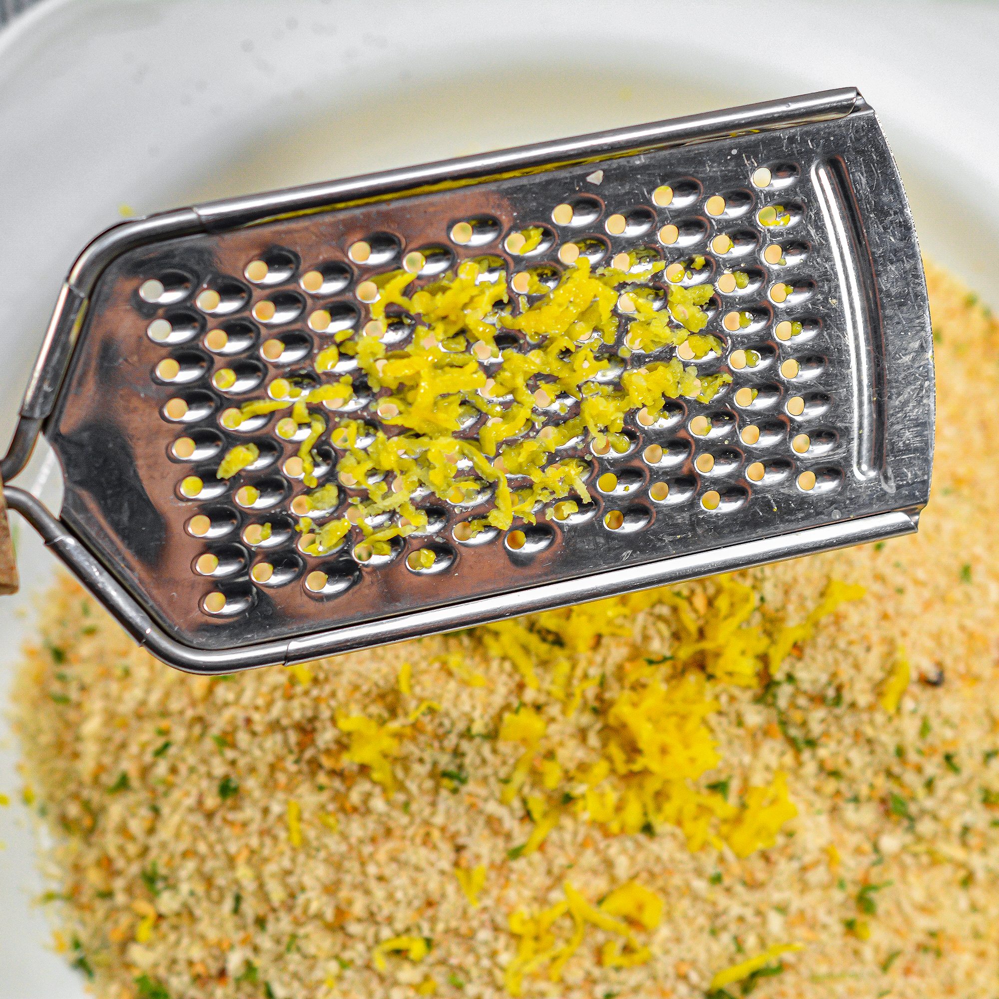 Add the breadcrumbs and lemon zest to another plate, and mix together well.