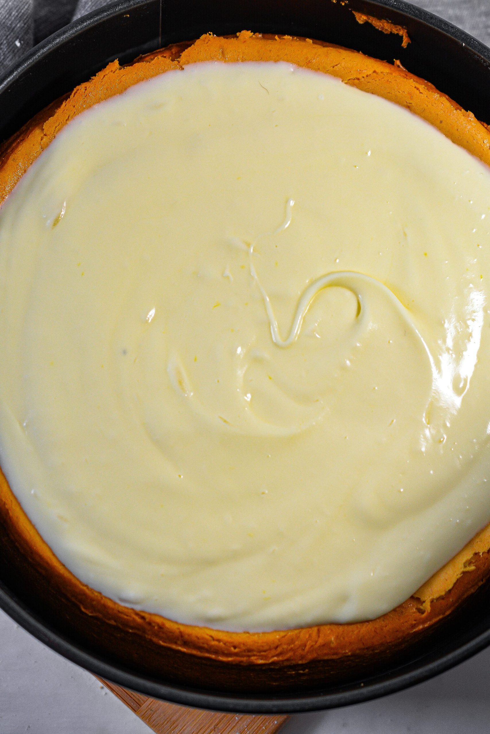 Spread the cream mixture over the top of the cheesecake.