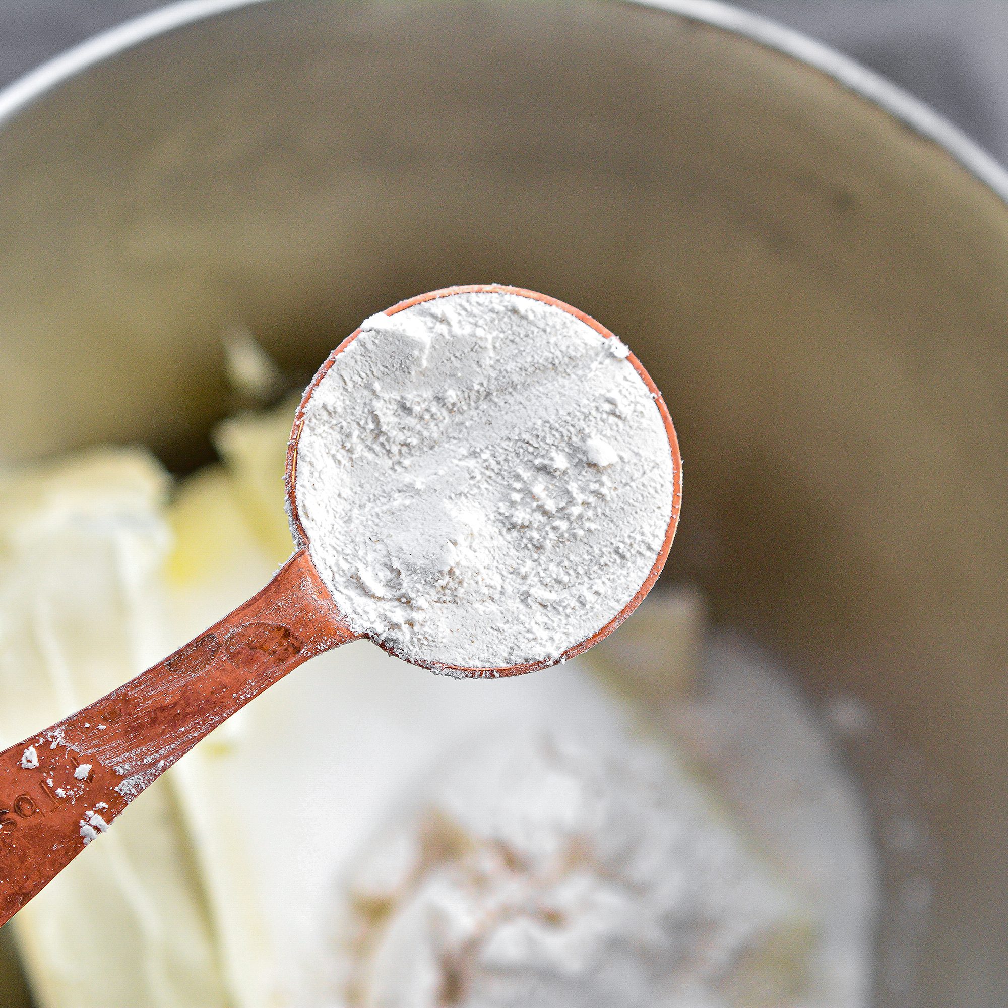 In a mixing bowl, combine the 24 oz cream cheese, 1 cup sugar, and 3 Tbsp flour. Mix until smooth and creamy.