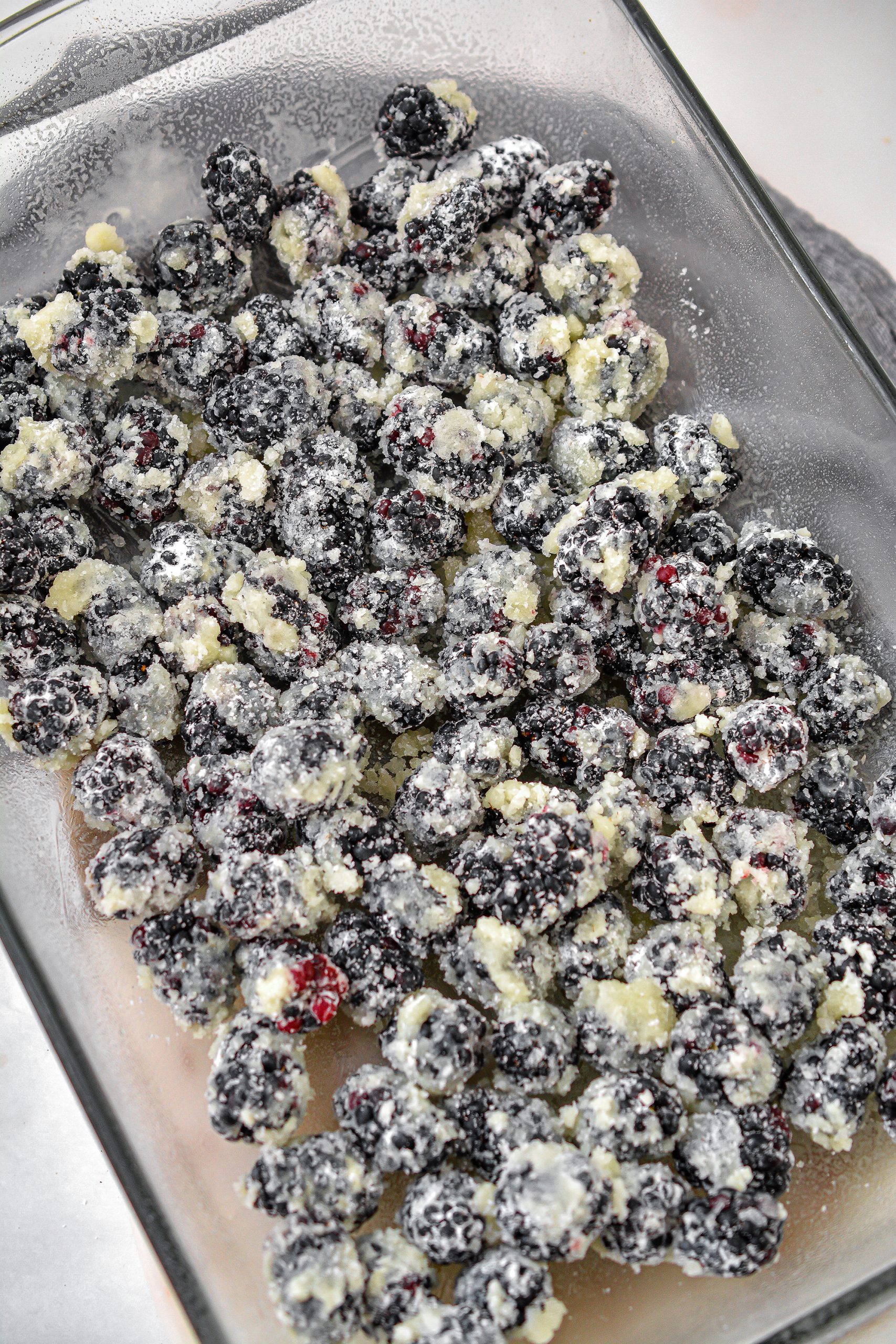 Layer the berries in the bottom of a well-greased 9x13 baking dish.
