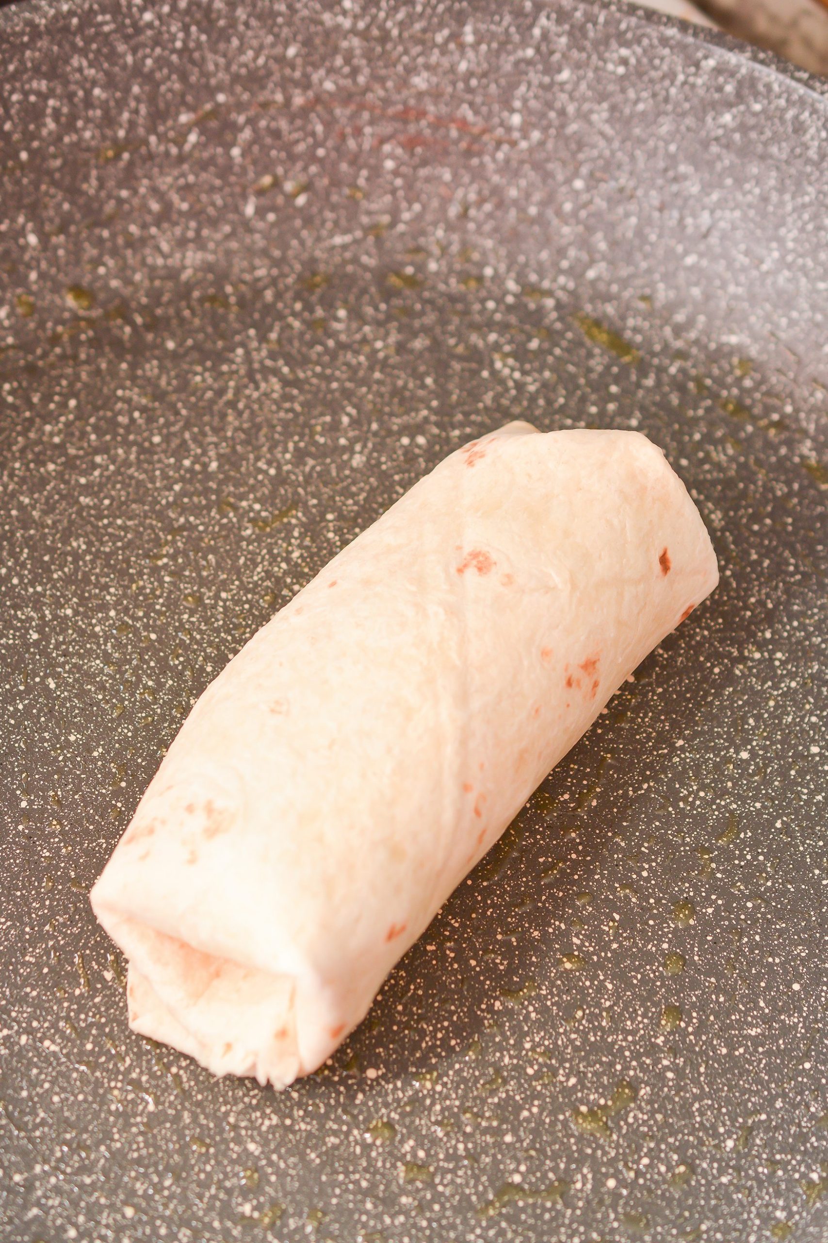 Fold in the sides of the tortillas and then roll them closed to form a burrito-like wrap.