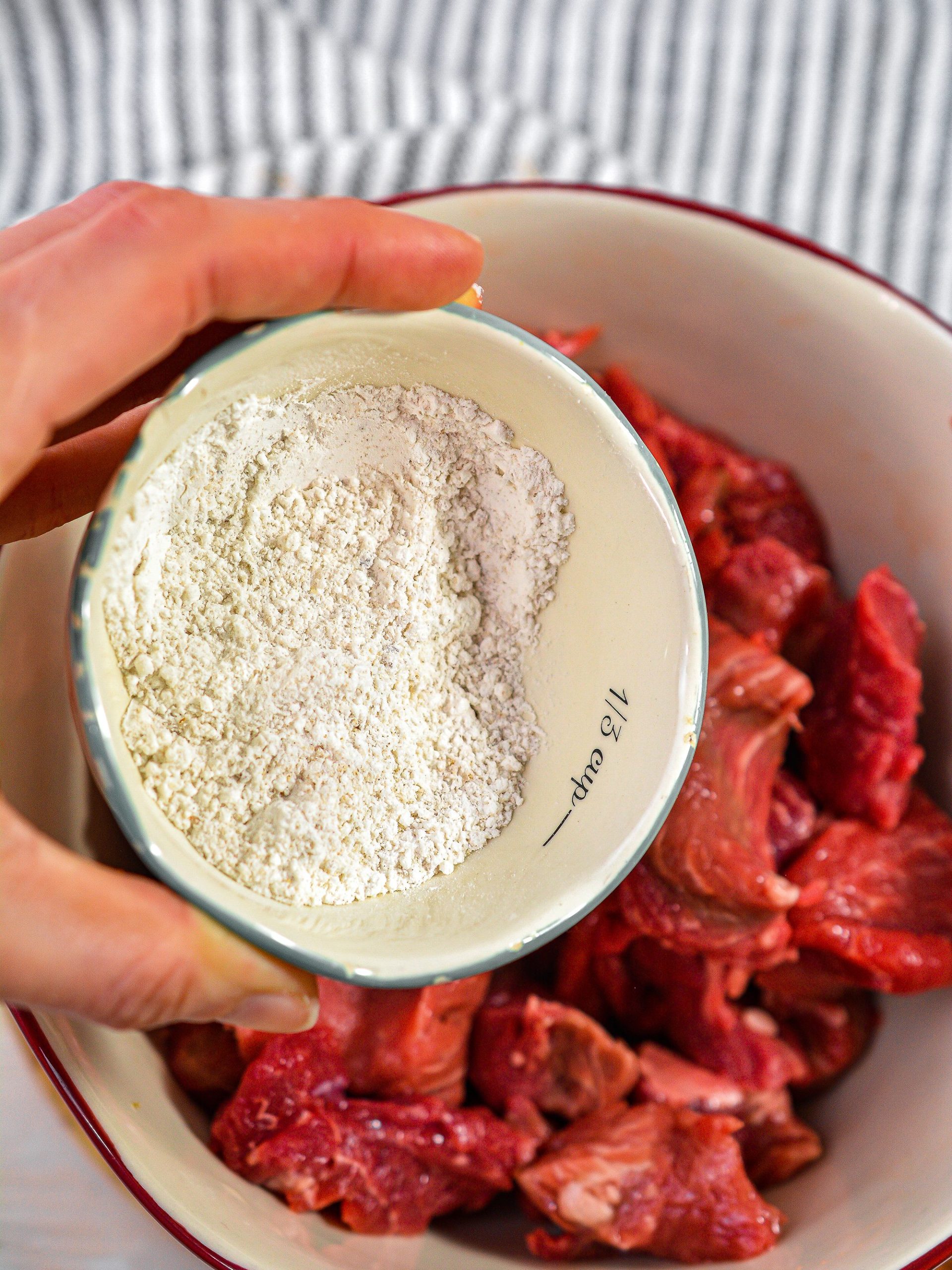 Sprinkle the seasoned flour over the meat and toss to coat well.