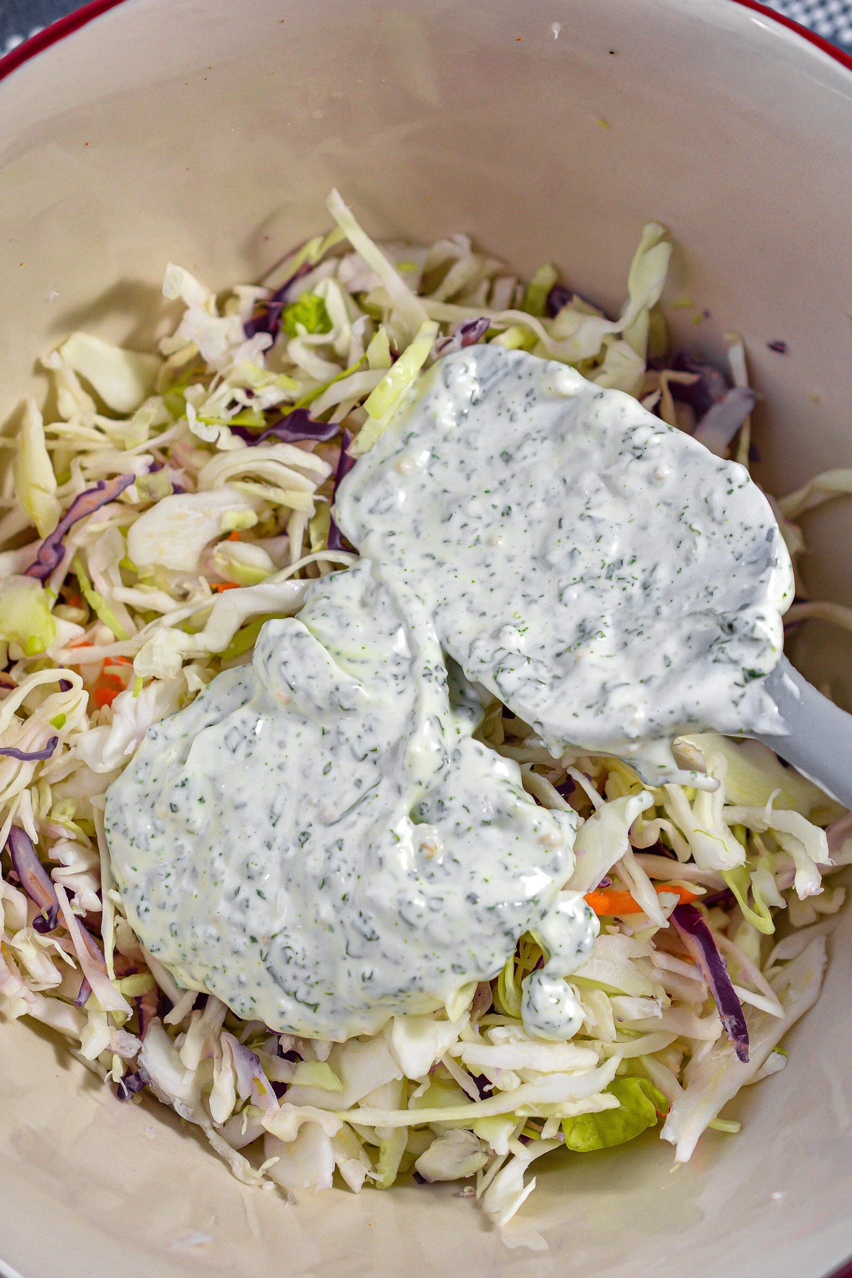 In another bowl, place some of the dressing on the coleslaw mix, and stir to combine well.