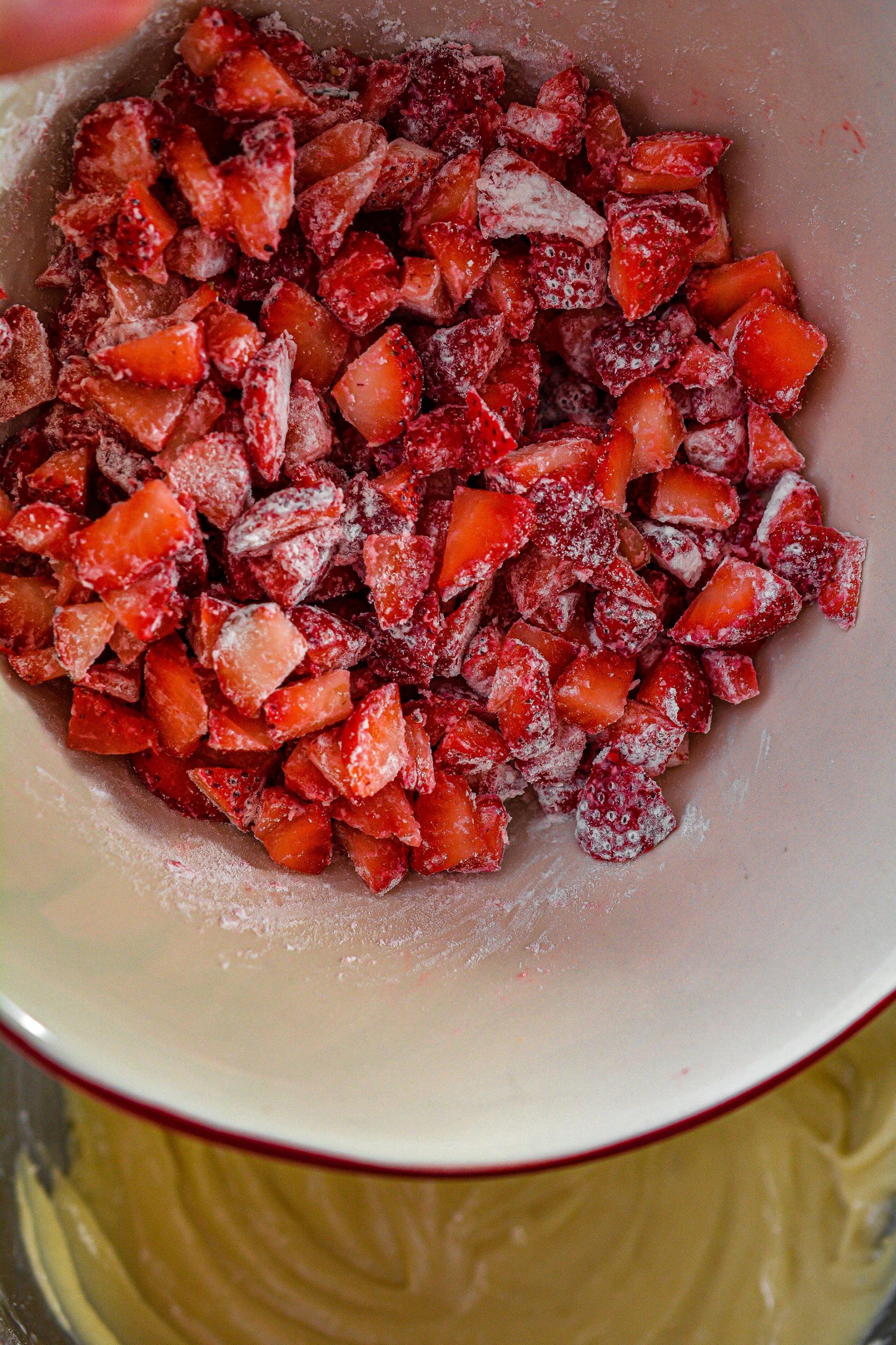 In a bowl, toss the 2 cups of diced strawberries in the 2 tbsp flour, and then fold them into the bread batter.