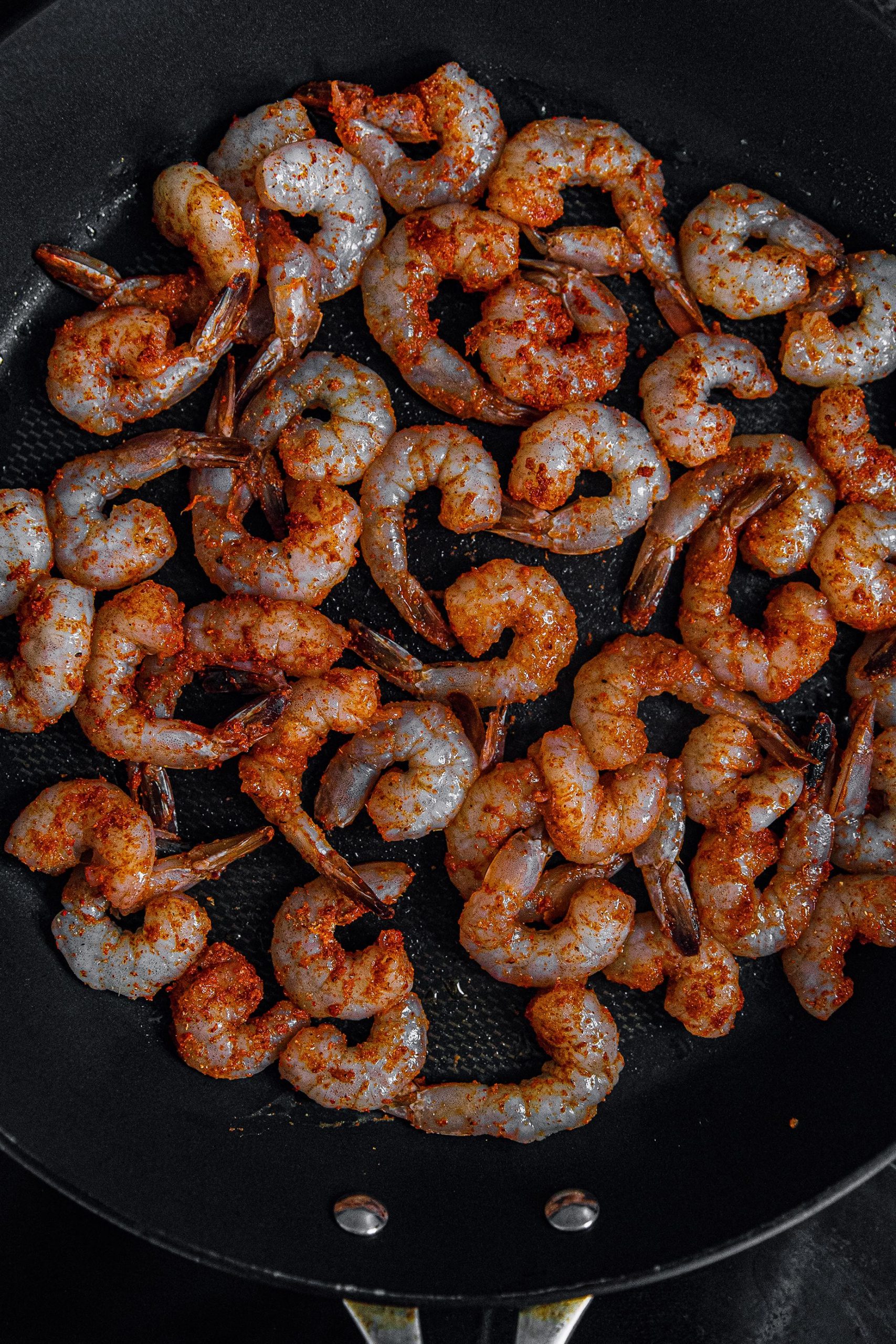 Add oil to a skillet on medium high heat and cook shrimp 2-3 minutes a side until pink and cooked through. 