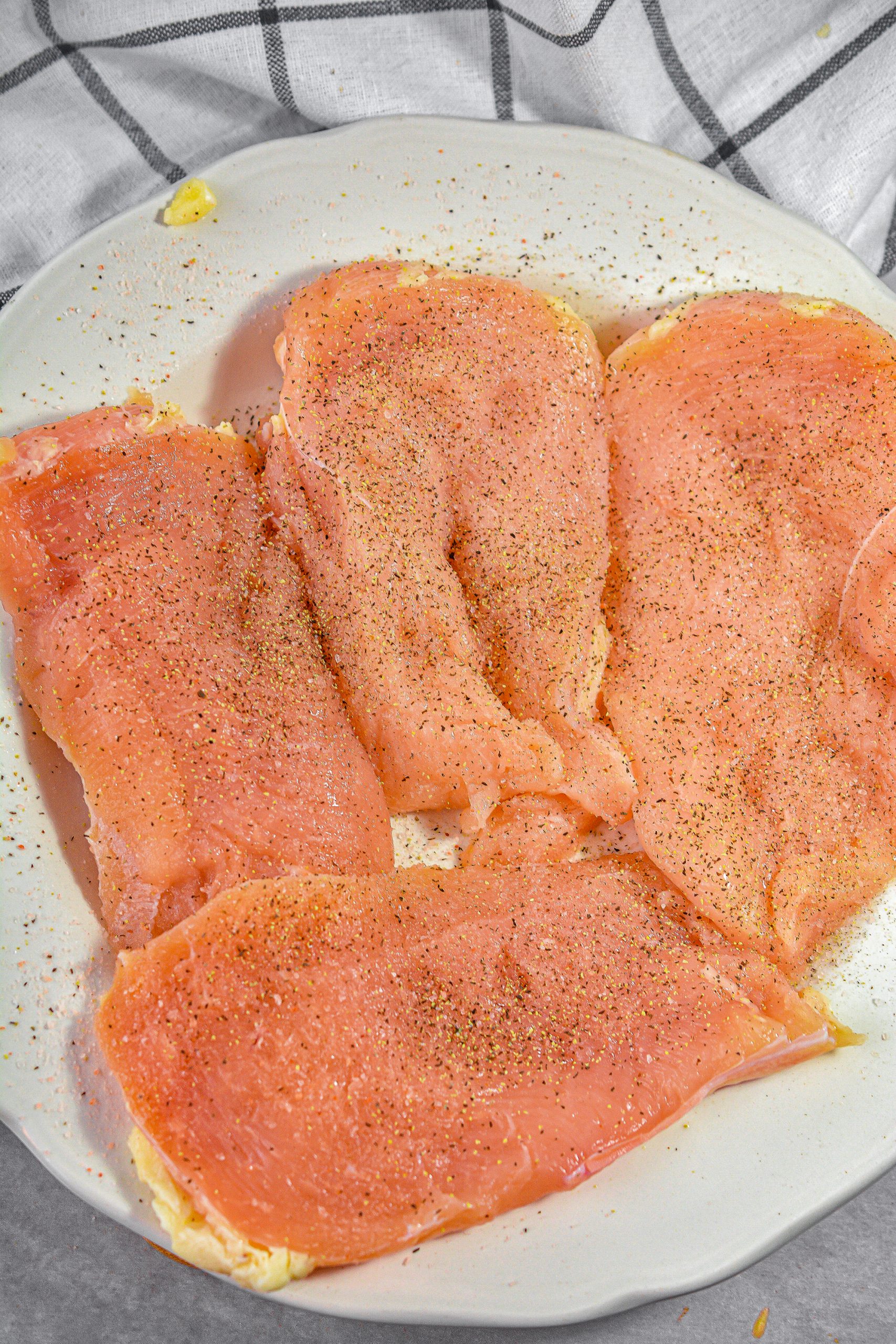 Season the chicken breasts with salt and pepper.