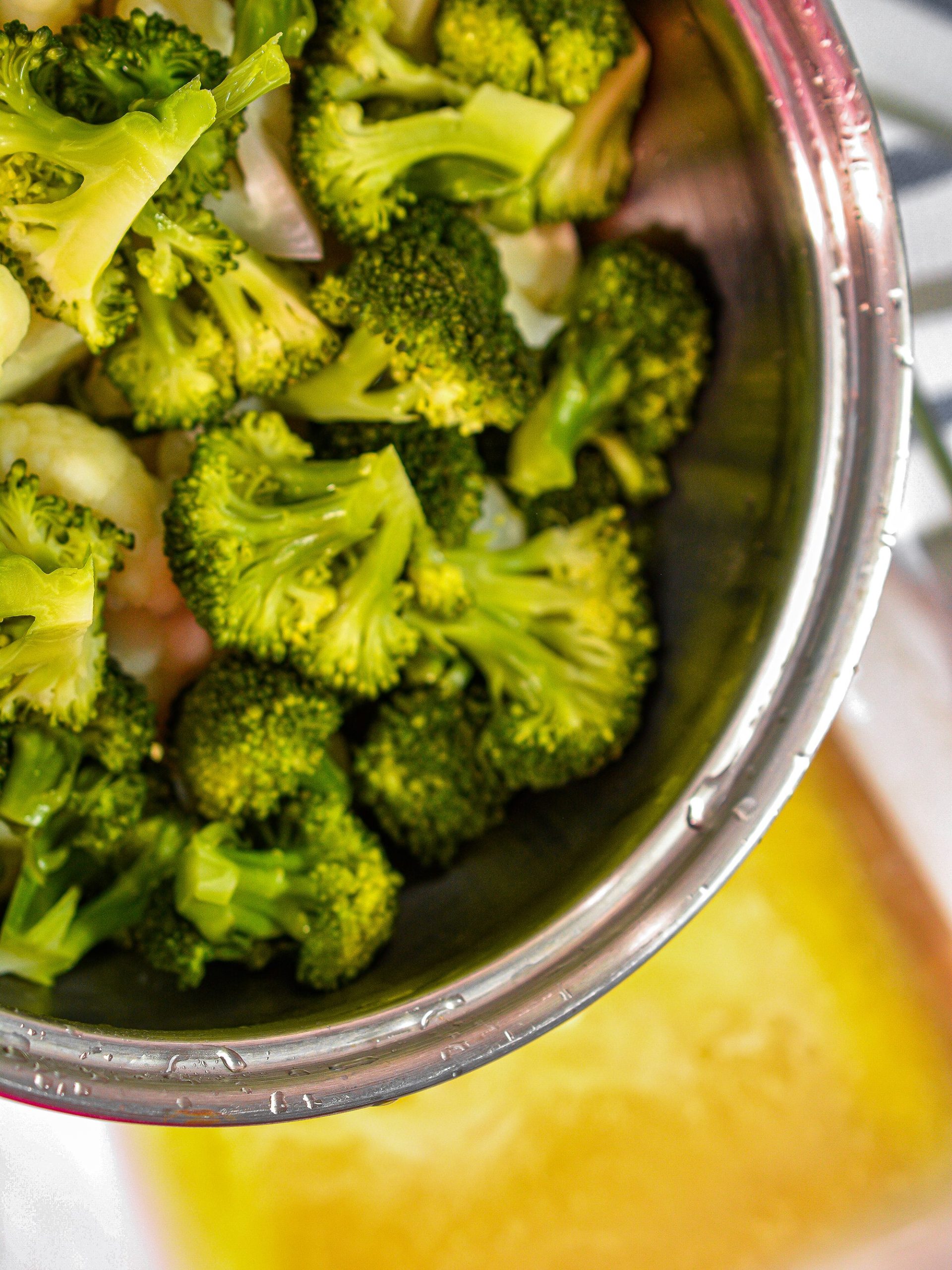  Steam the cauliflower and broccoli for 5 minutes, and layer into the bottom of a well-greased 9x13 baking dish.