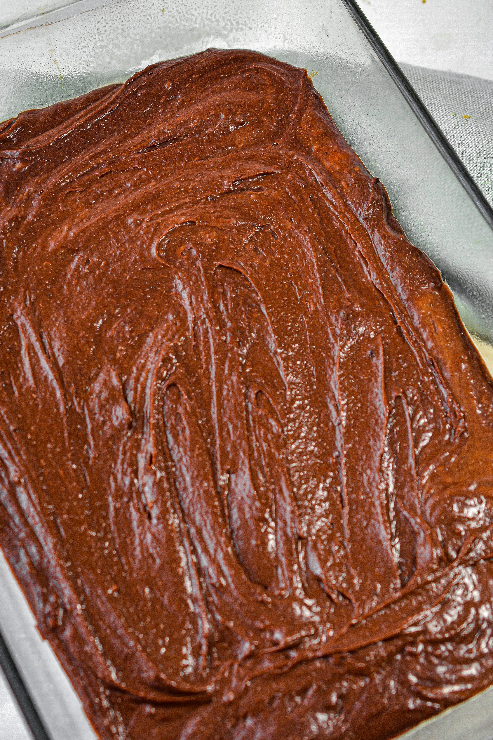 Spread the brownie mixture into the bottom of a well-greased 9x13 baking dish.