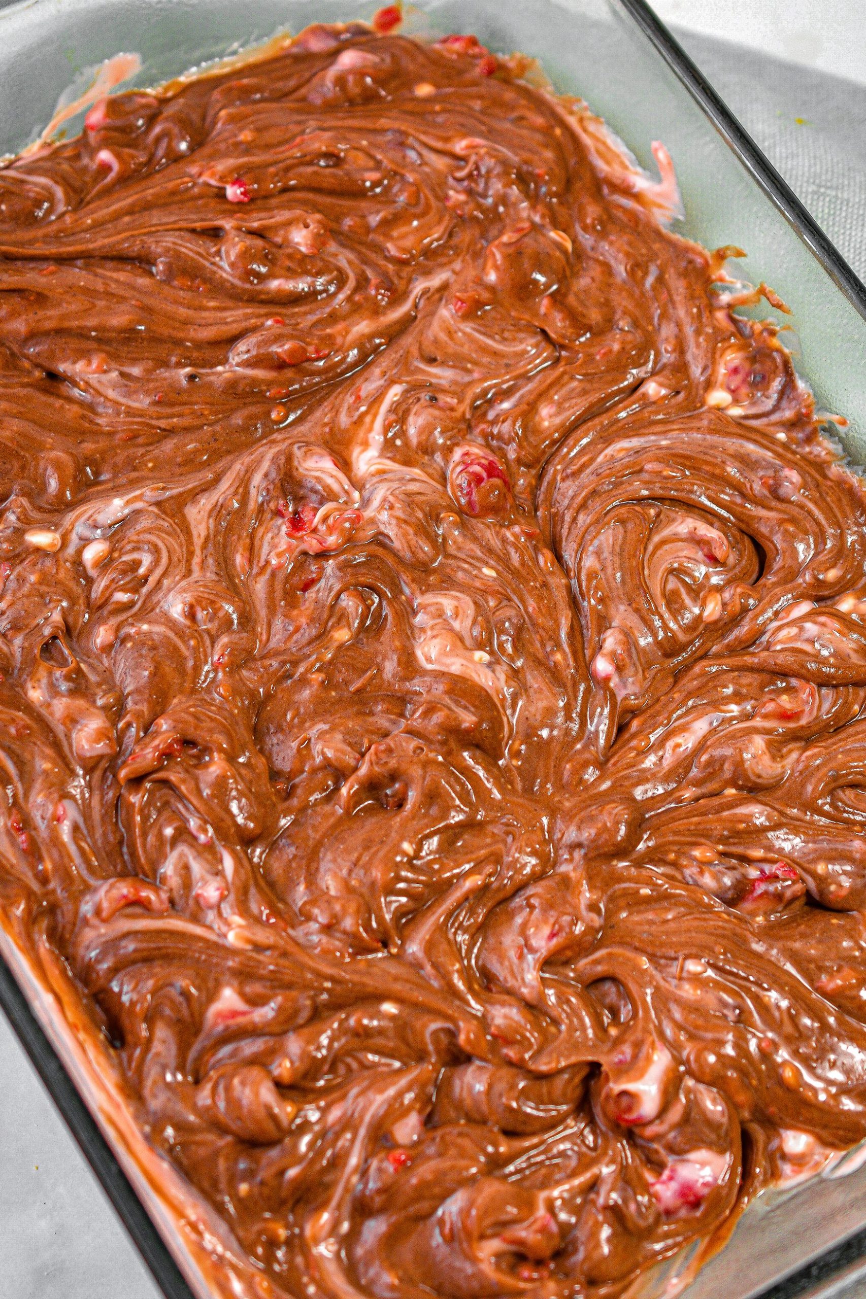 Spread the cheesecake mixture over the brownie mixture and swirl with a butter knife.