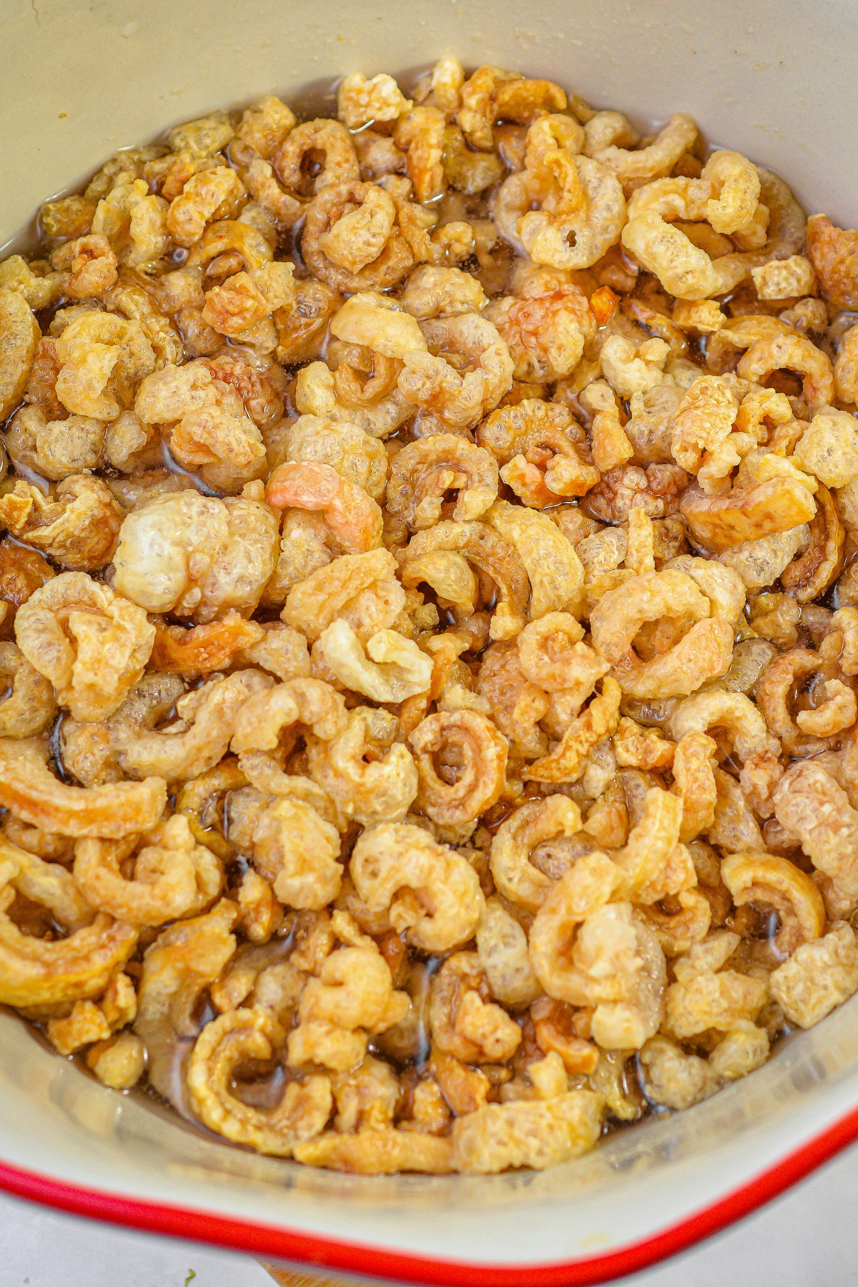 Place the cracklins in a large bowl and cover with water. Allow to soak for 20 minutes.