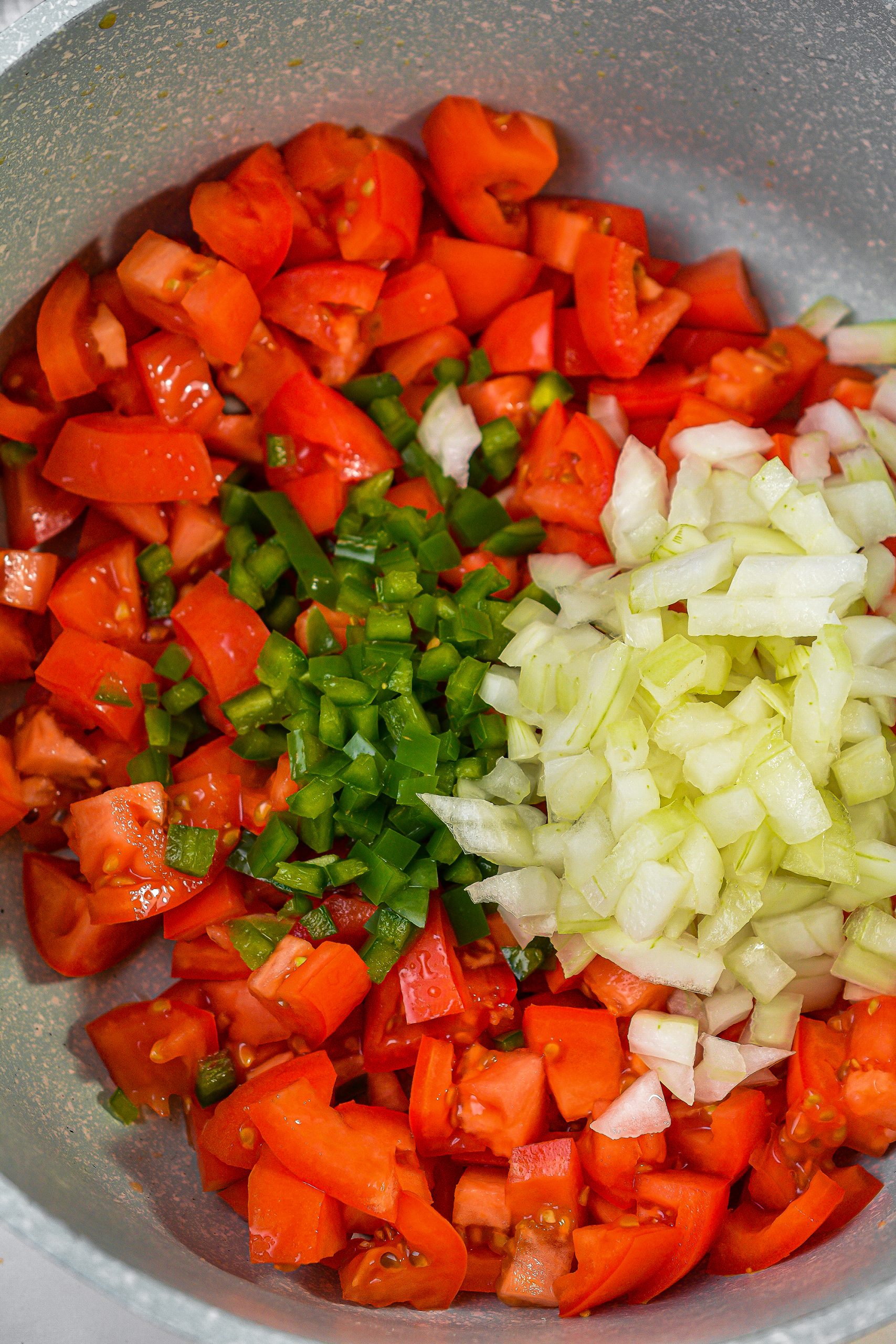 While the cracklins are soaking, add the tomatoes, onion and jalapeno to a large pot over medium heat on the stove.
