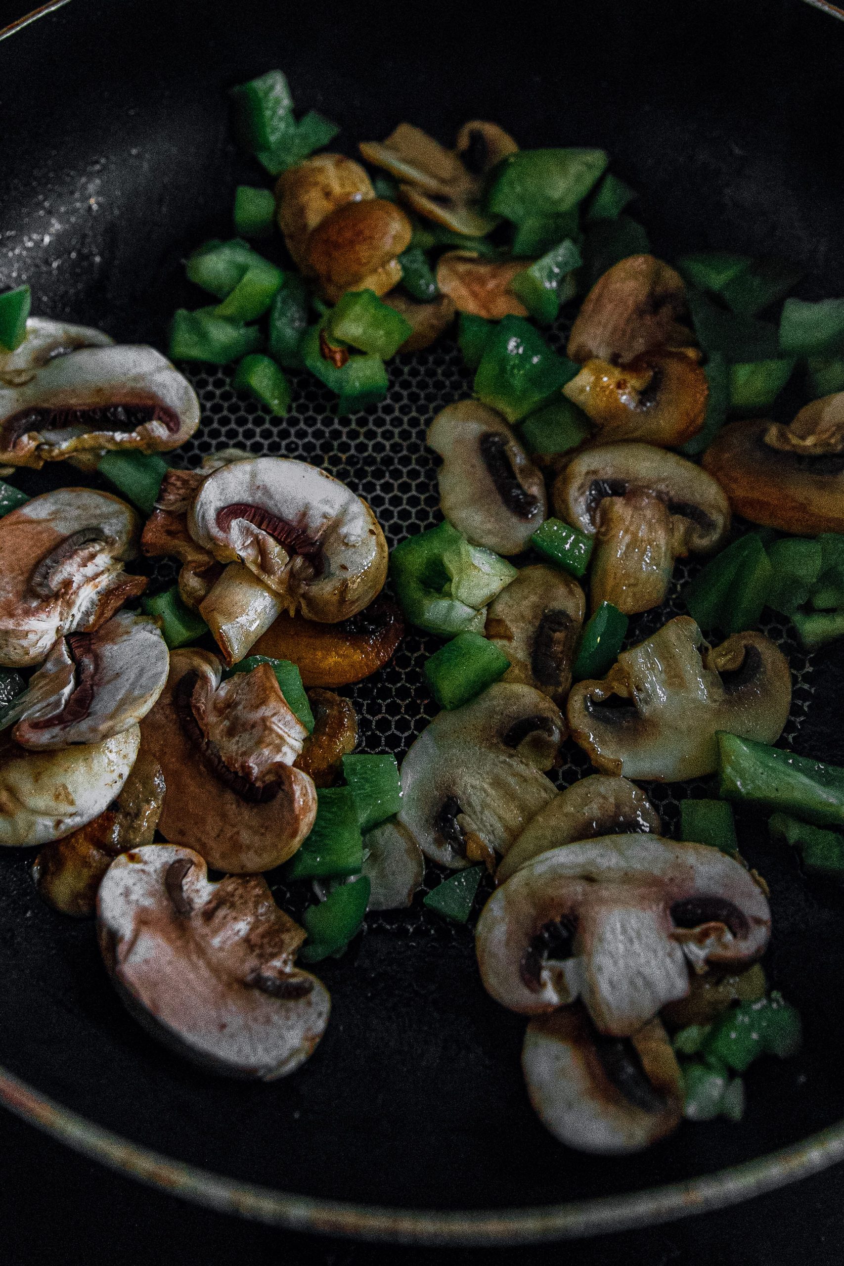  In a large skillet over medium-high heat, melt. Add bell pepper and mushrooms and sauté until tender.