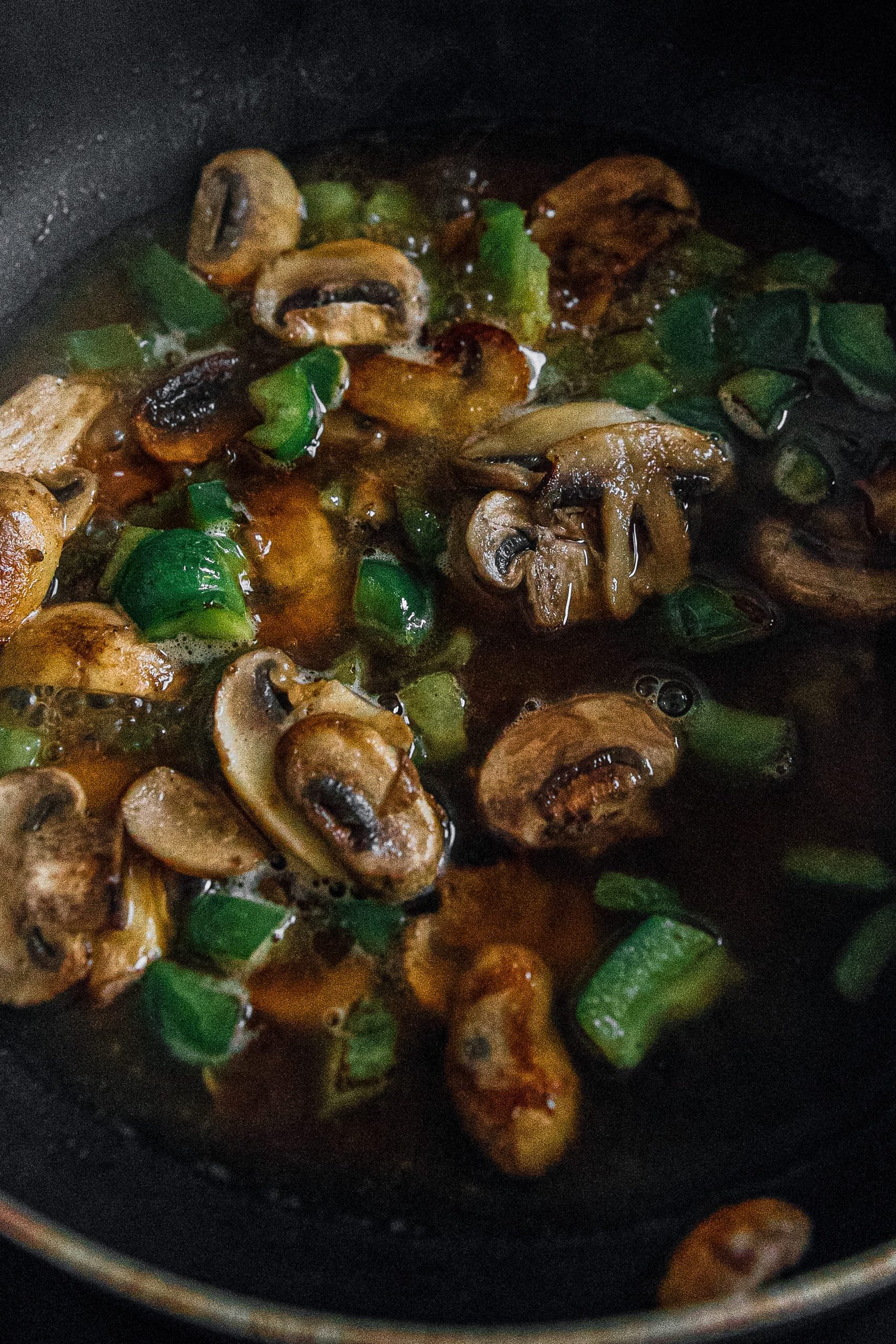  In a large skillet over medium-high heat, melt. Add bell pepper and mushrooms and sauté until tender.
