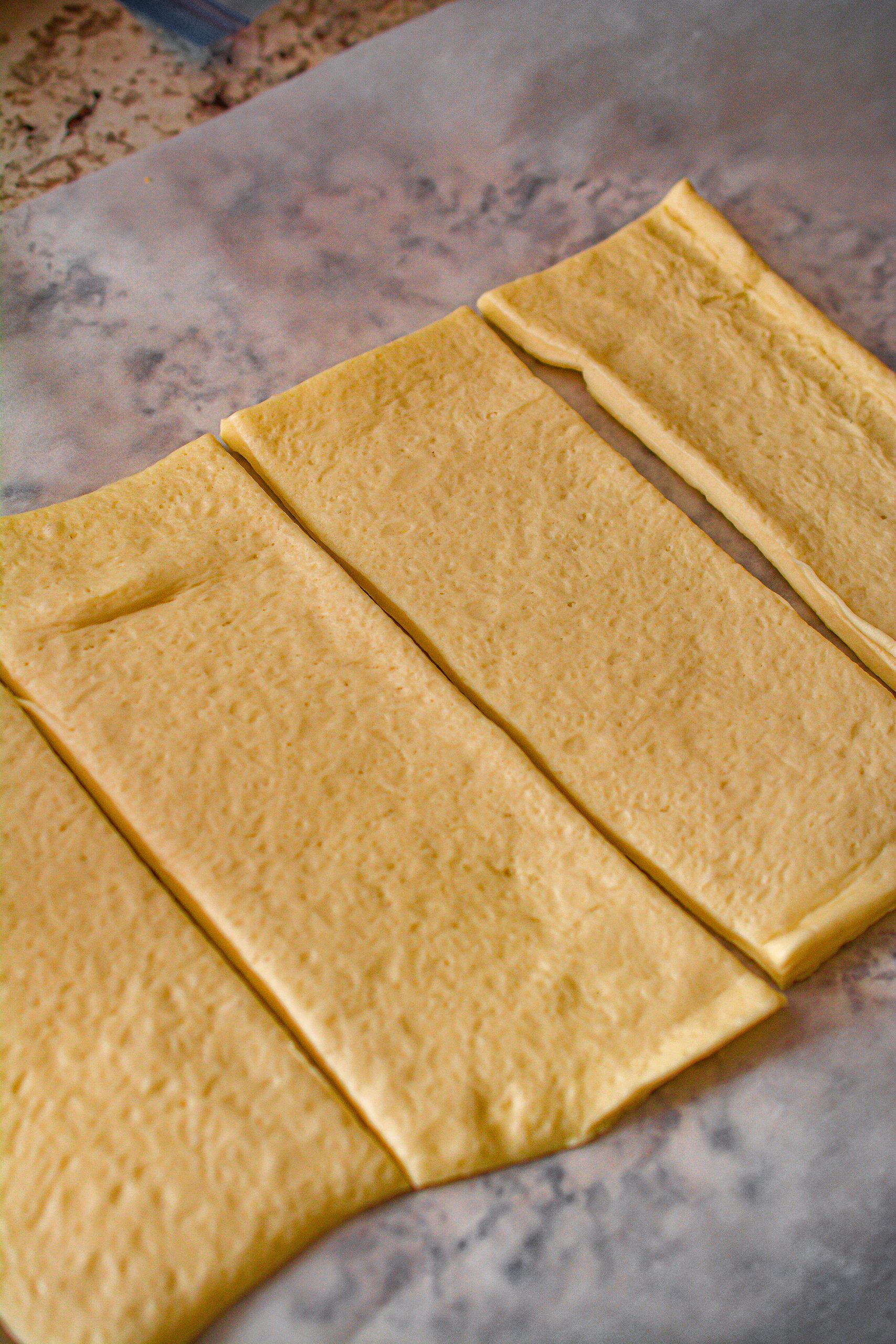 Roll out the pizza dough and slice it into 4 even rectangular pieces.