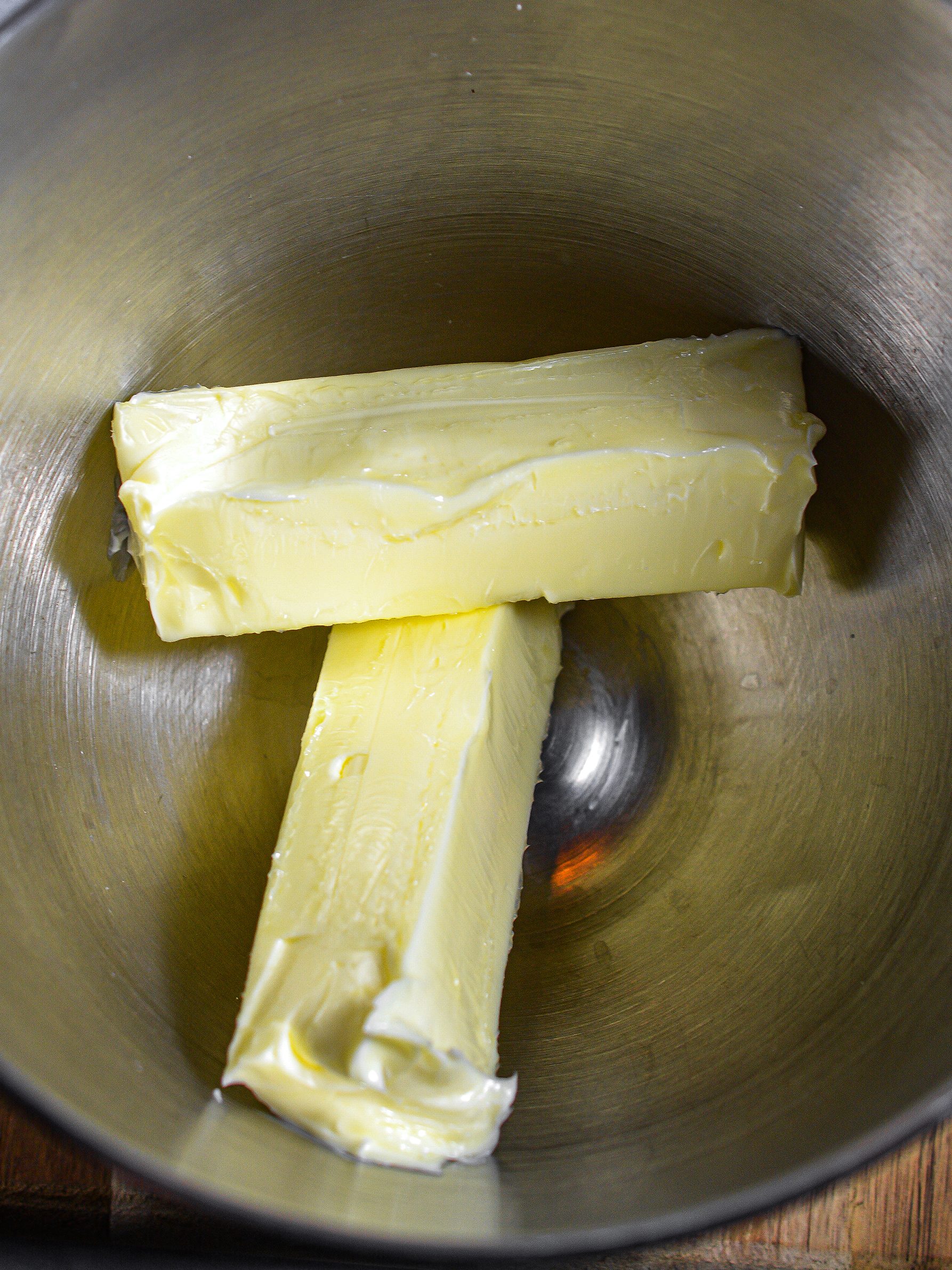 Place the butter into a mixing bowl, and blend until creamy. 