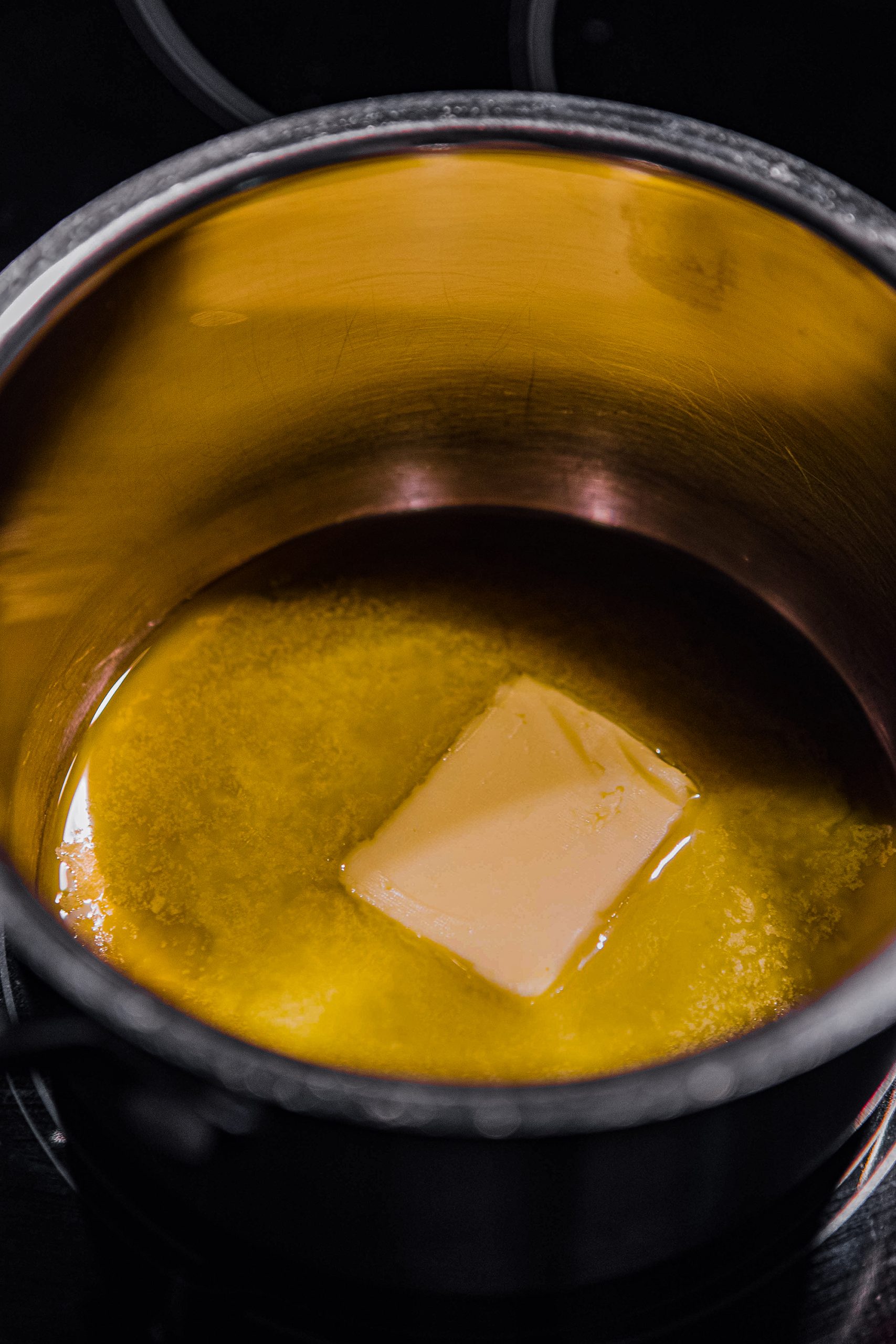 Over medium heat, melt 4 tablespoons of butter in a saucepan. Add the cream and simmer for 4-5 minutes, until just thickened. 