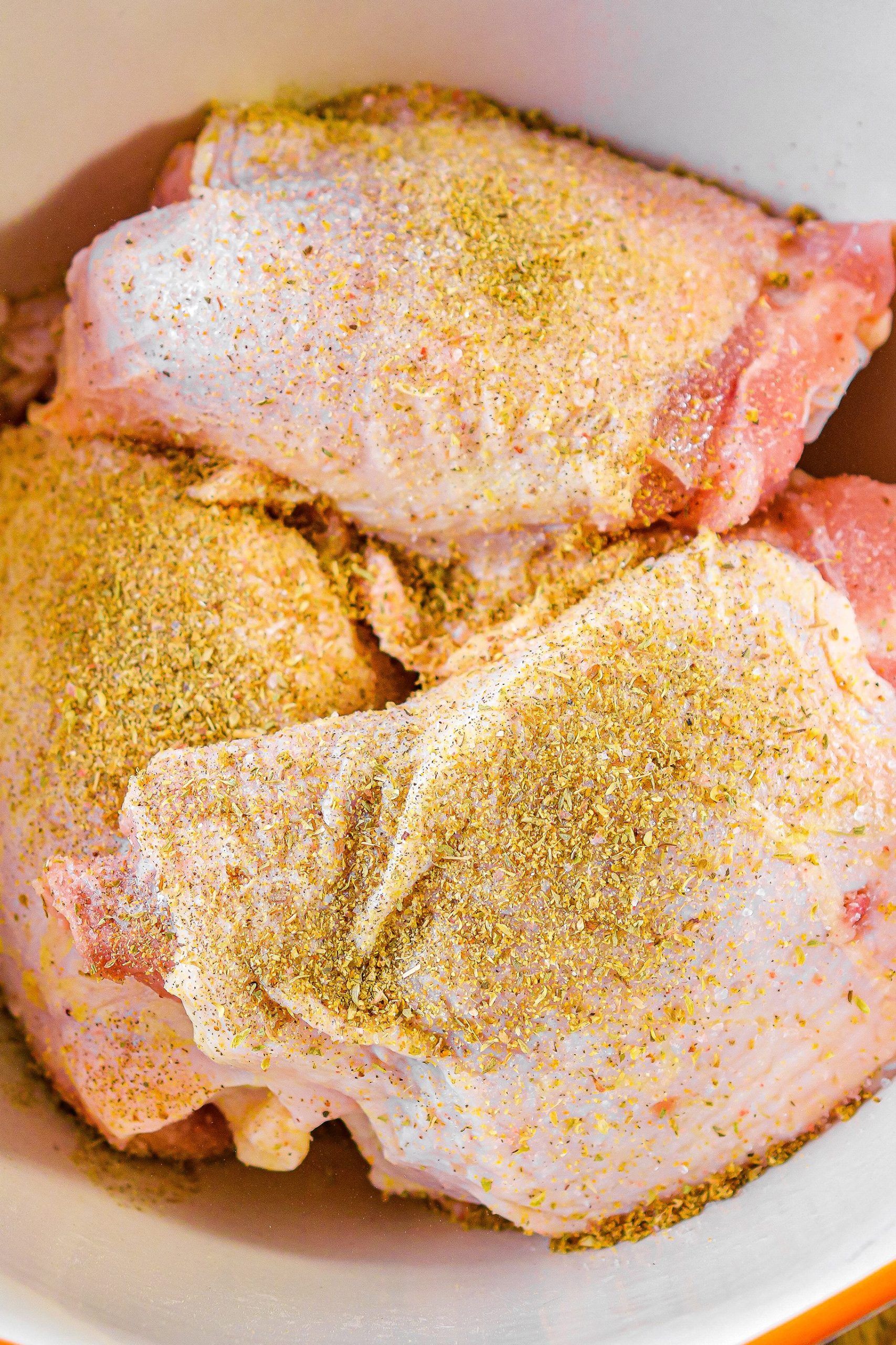 Season the chicken thighs with salt and lemon pepper seasoning.