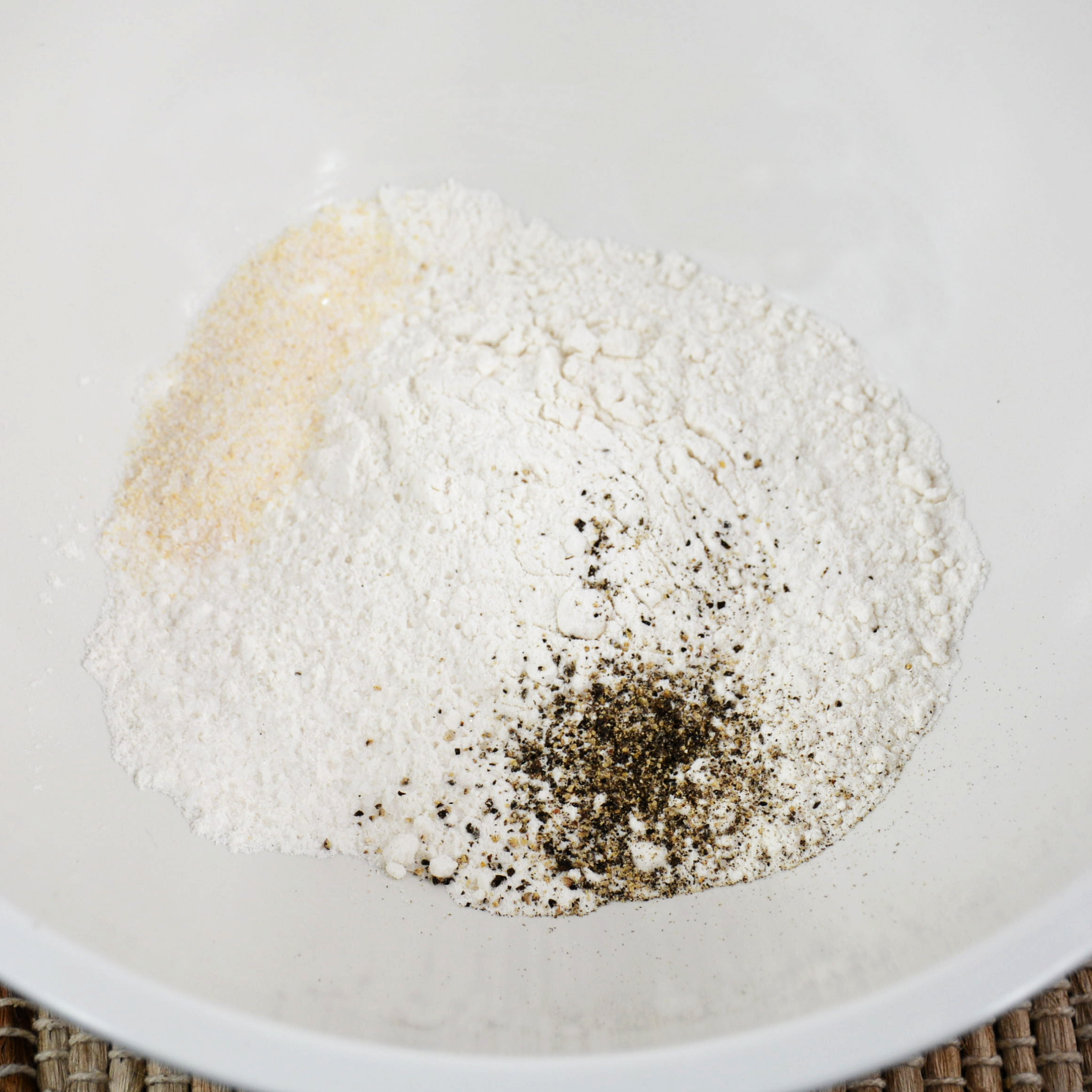 Combine flour, garlic salt, and black pepper in a pie plate or shallow dish.