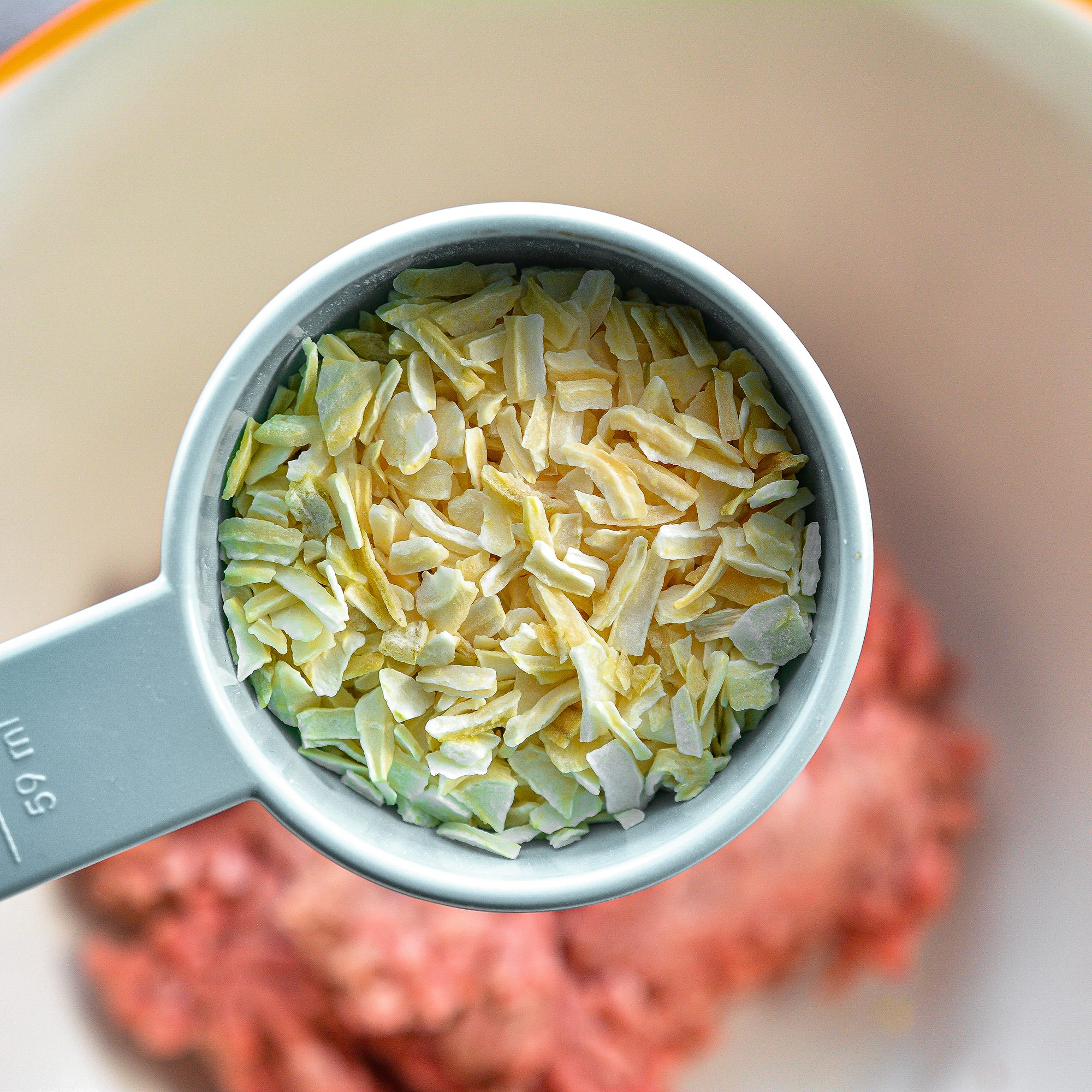 In a smaller bowl, combine the ground beef, minced onion, egg, bread crumbs, and salt and pepper to taste.