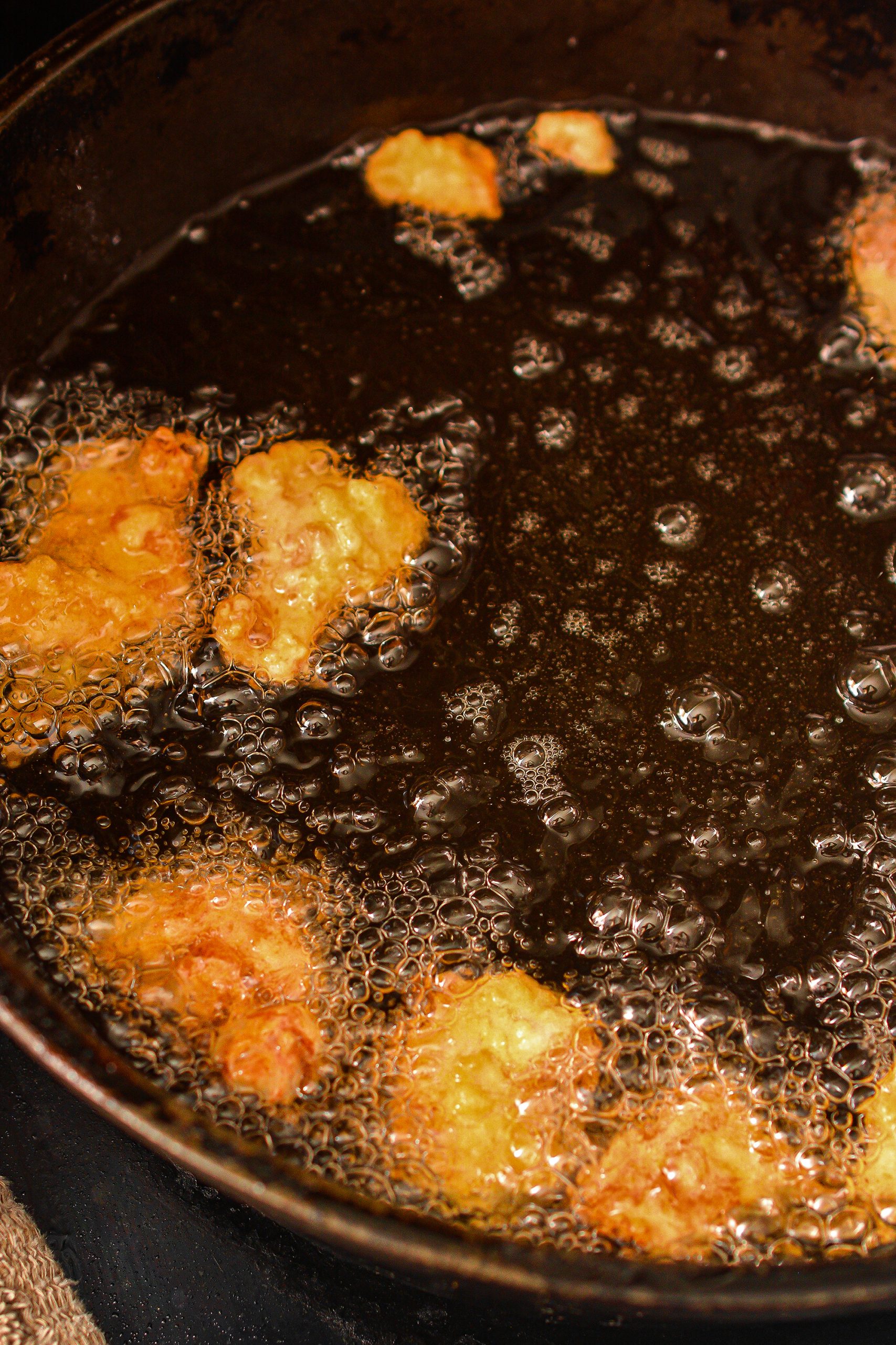 Add the coated chicken one piece at a time to the hot oil and fry until golden brown and cooked through.