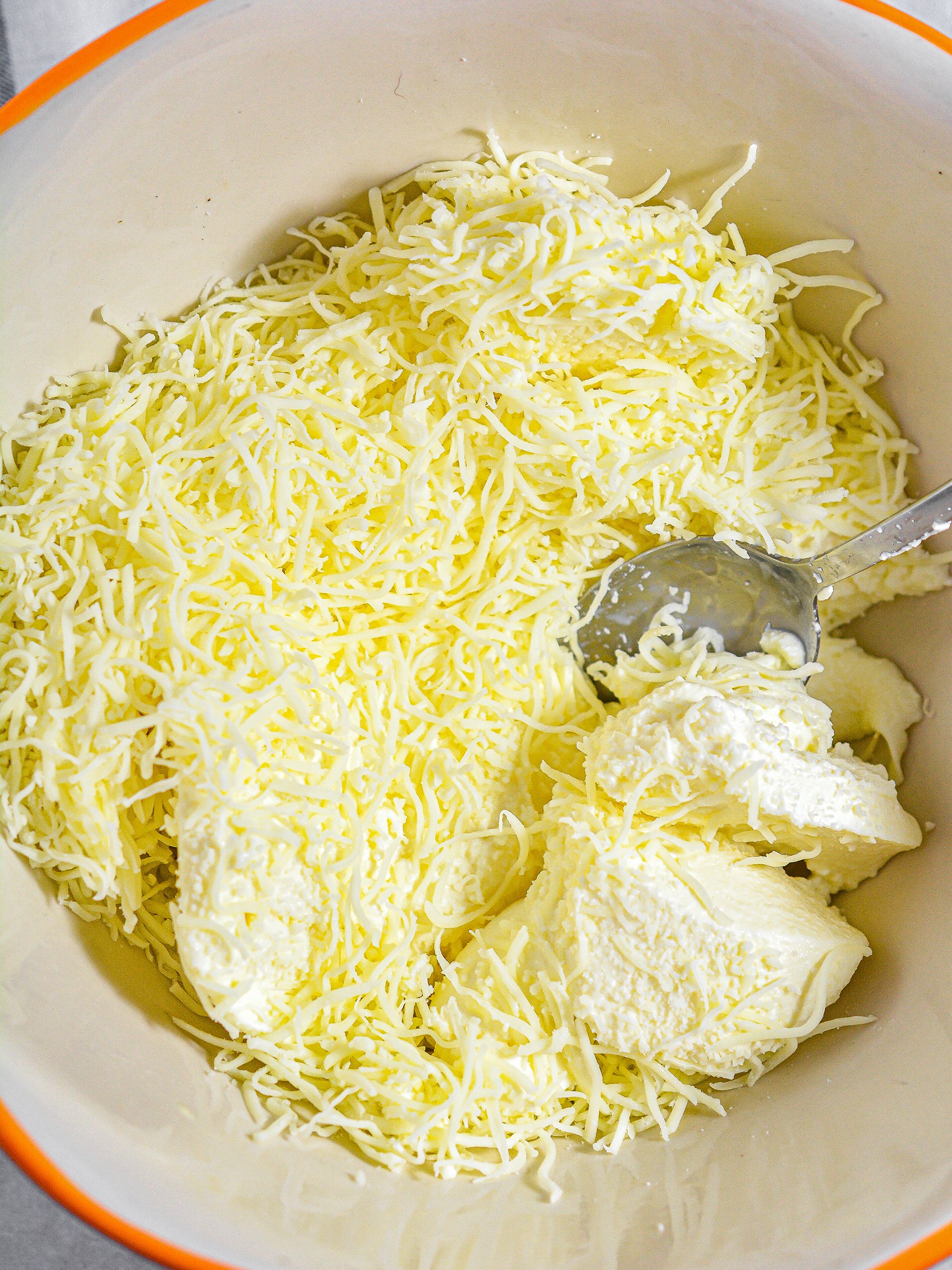 Adding the ricotta cheese and the mozzarella cheese.