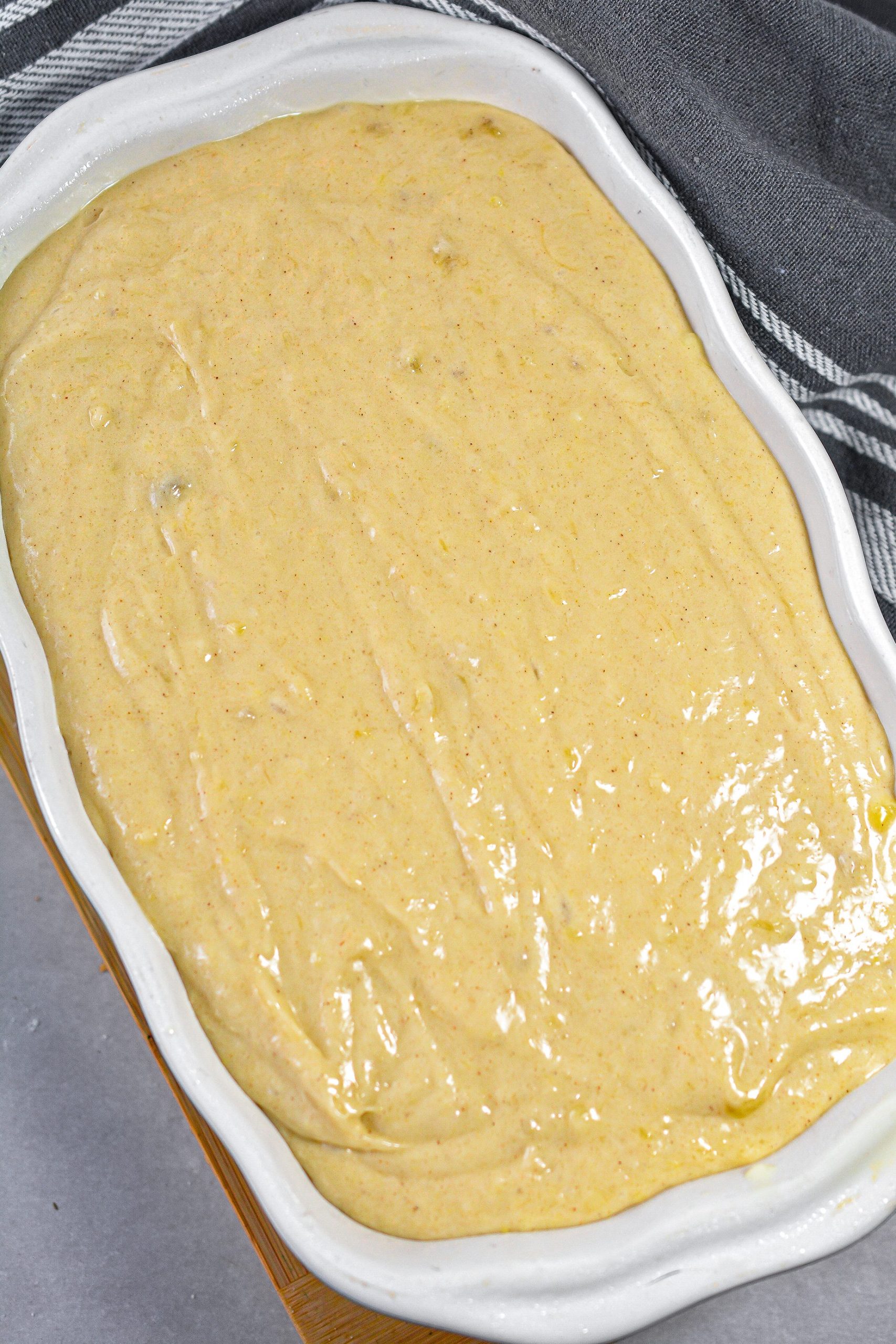 Pour the batter into a loaf pan that is well greased.