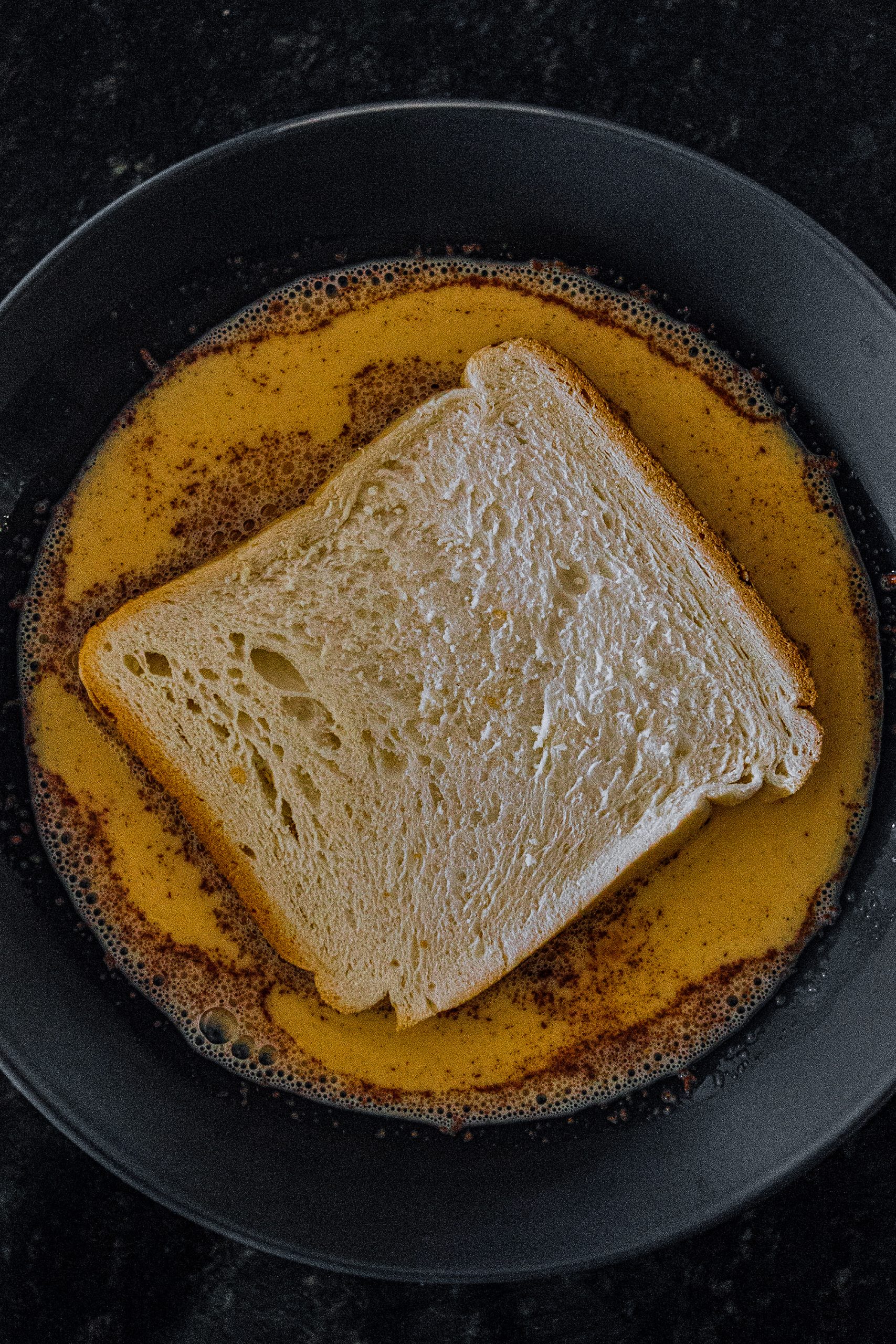 Place each slice of bread in egg mixture, ensuring both sides are soaked.