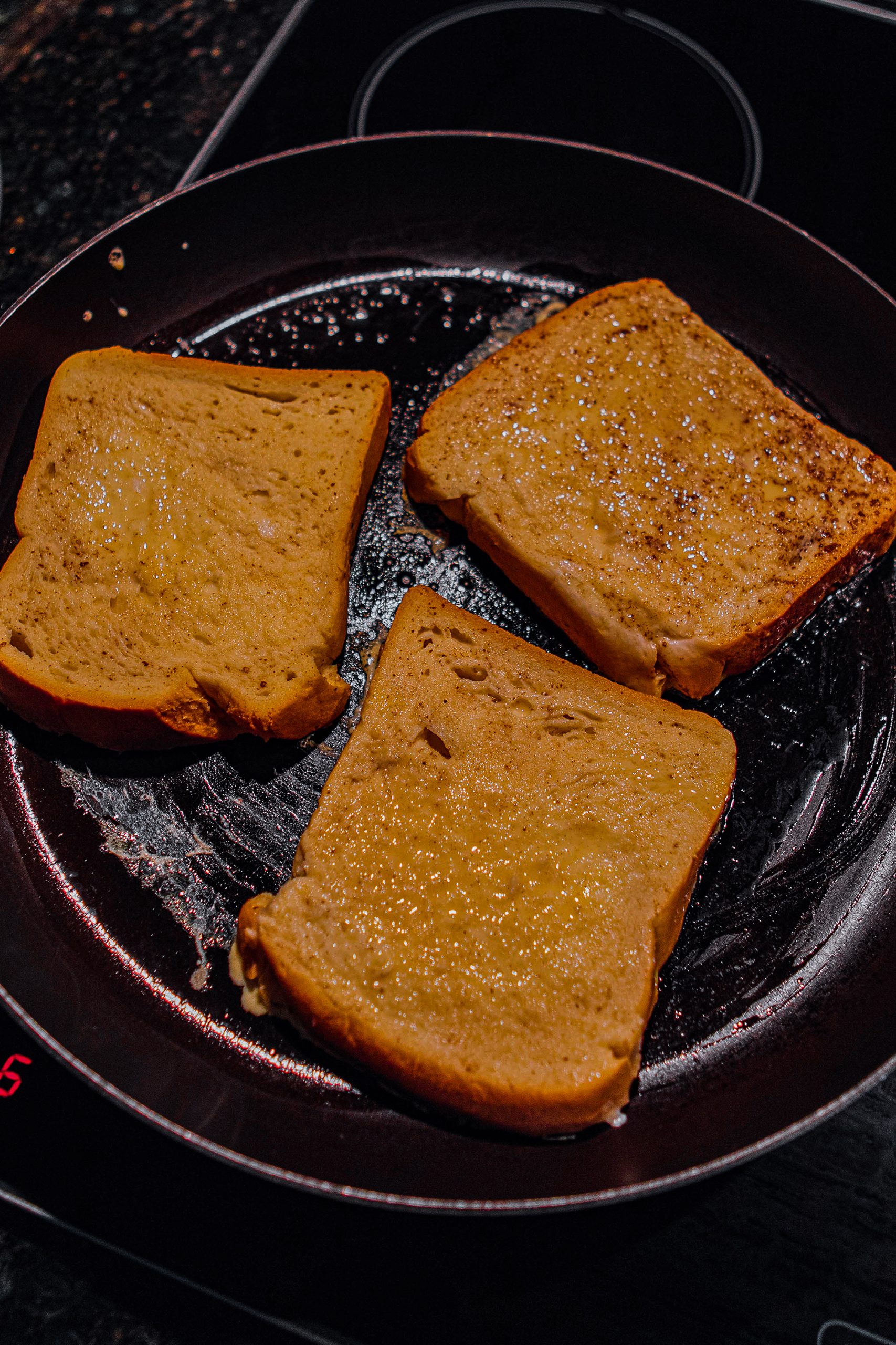 Place soaked bread onto pan, cooking on each side for a few minutes until golden.