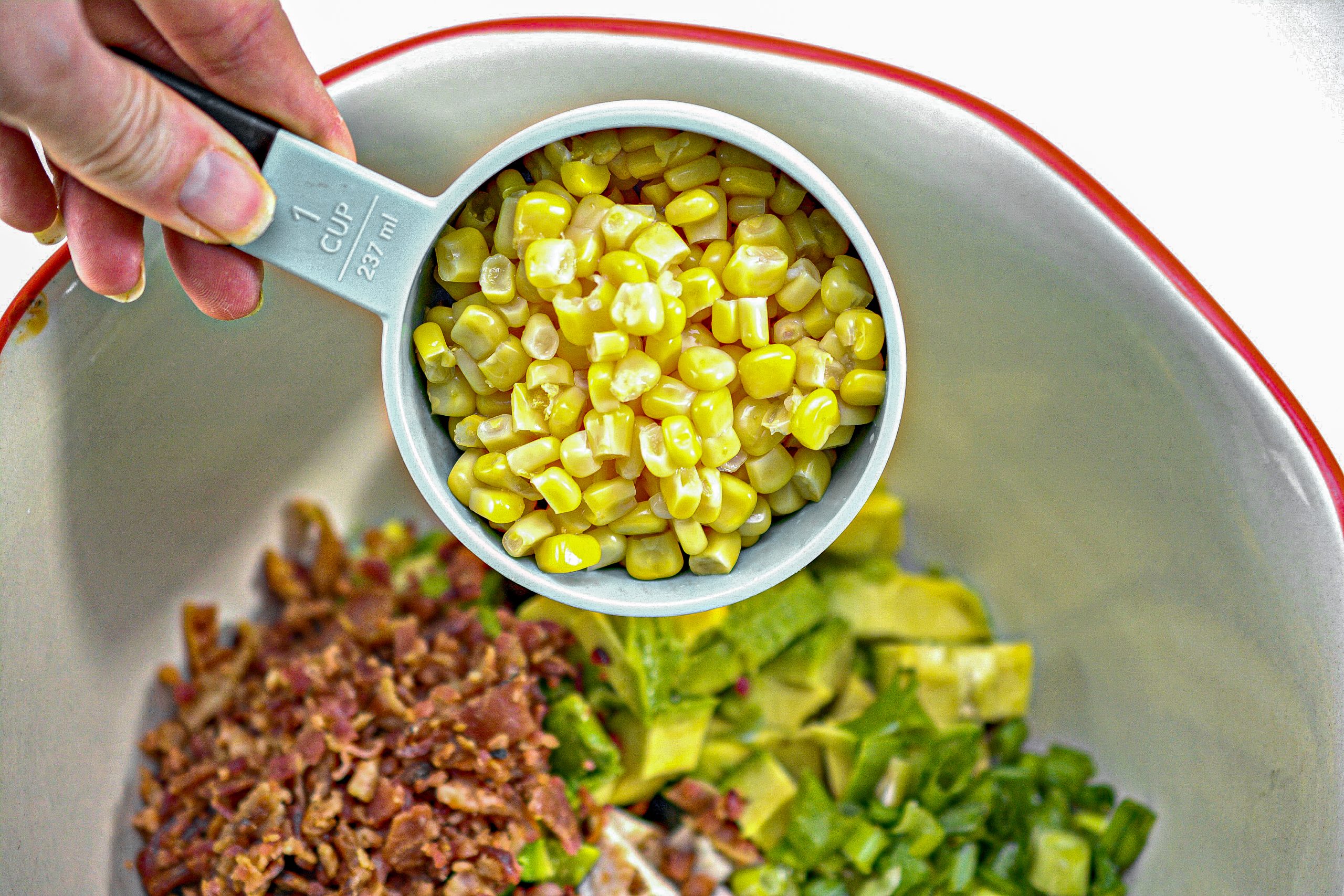 In a large mixing bowl, combine the chicken, chopped avocado, corn, green onion, bacon crumbles, dill and parsley.