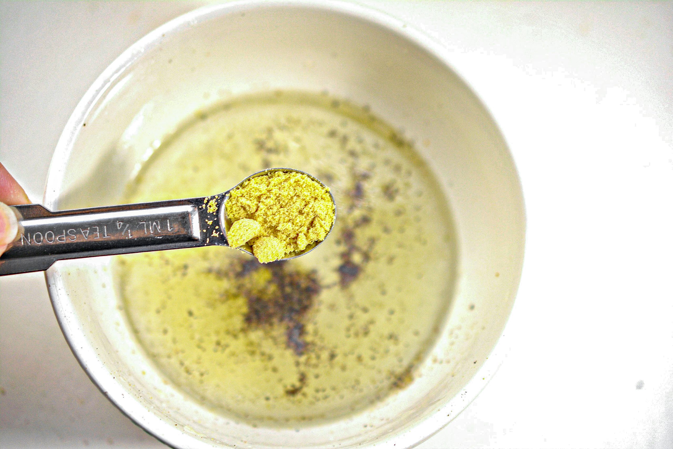 In a small bowl, whisk together the olive oil, lemon juice, ground mustard and salt and pepper to taste.