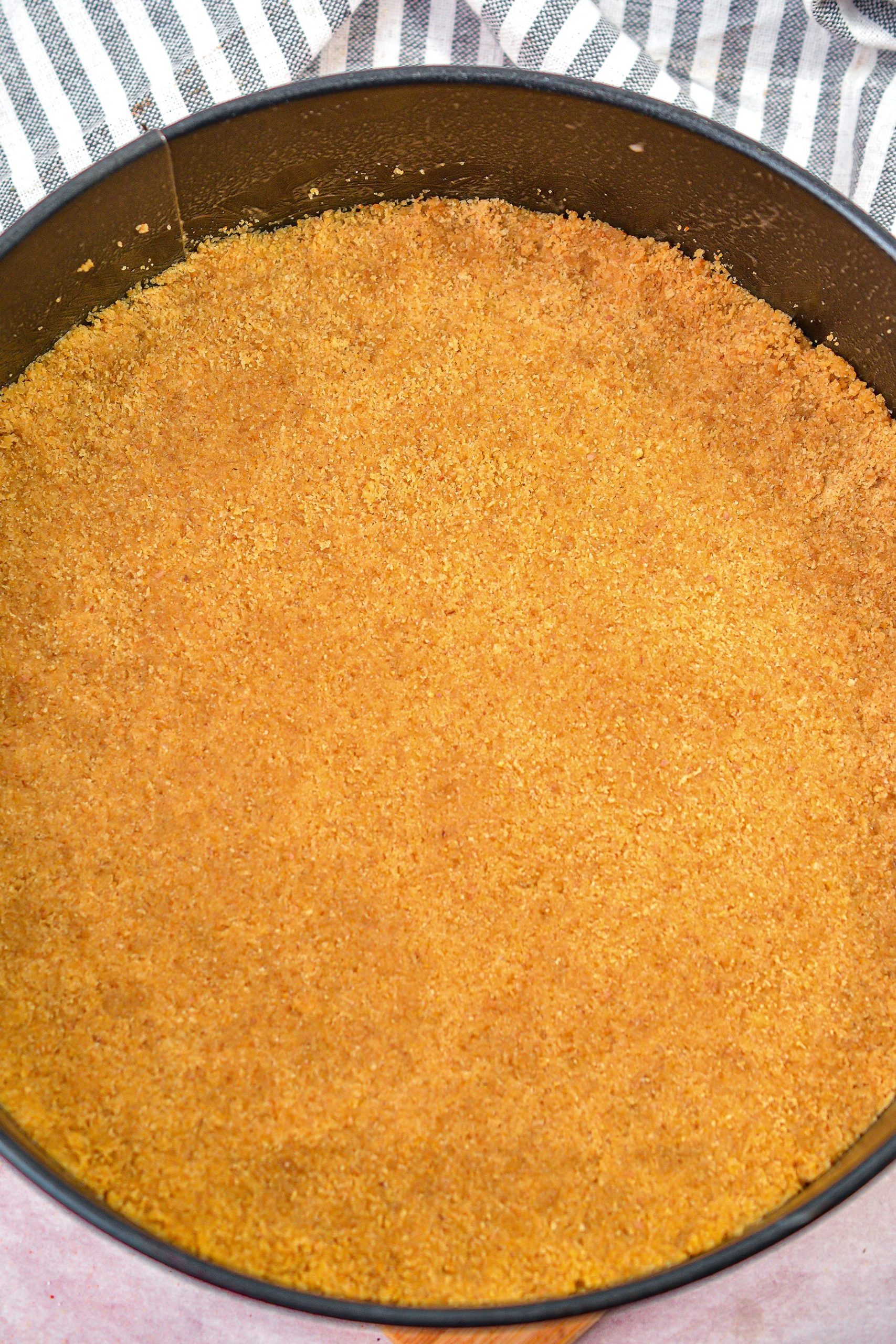 Press the crust mixture into a well-greased 9-inch springform pan.