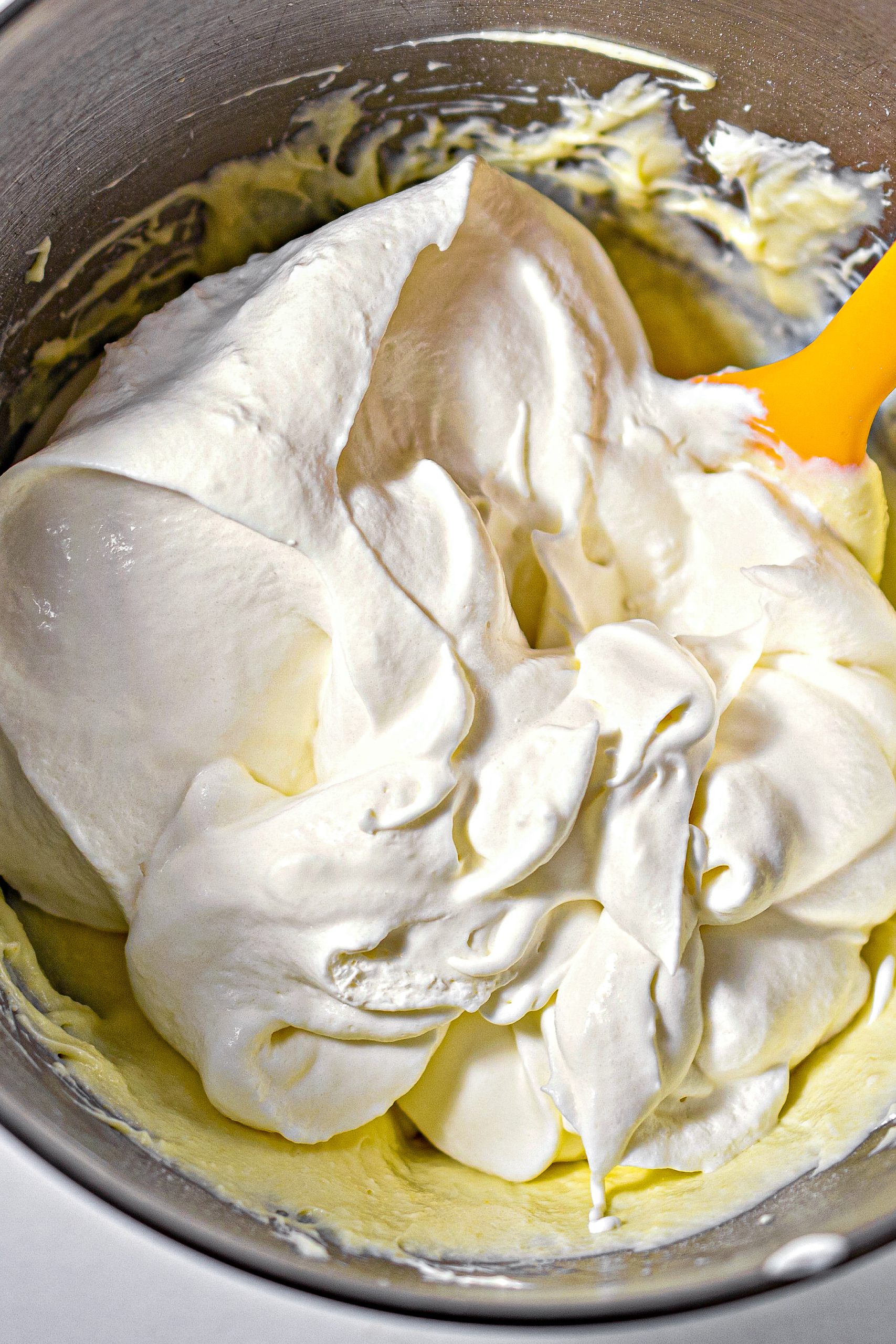 Fold the whipped topping into the mixture by hand, until it is completely blended.