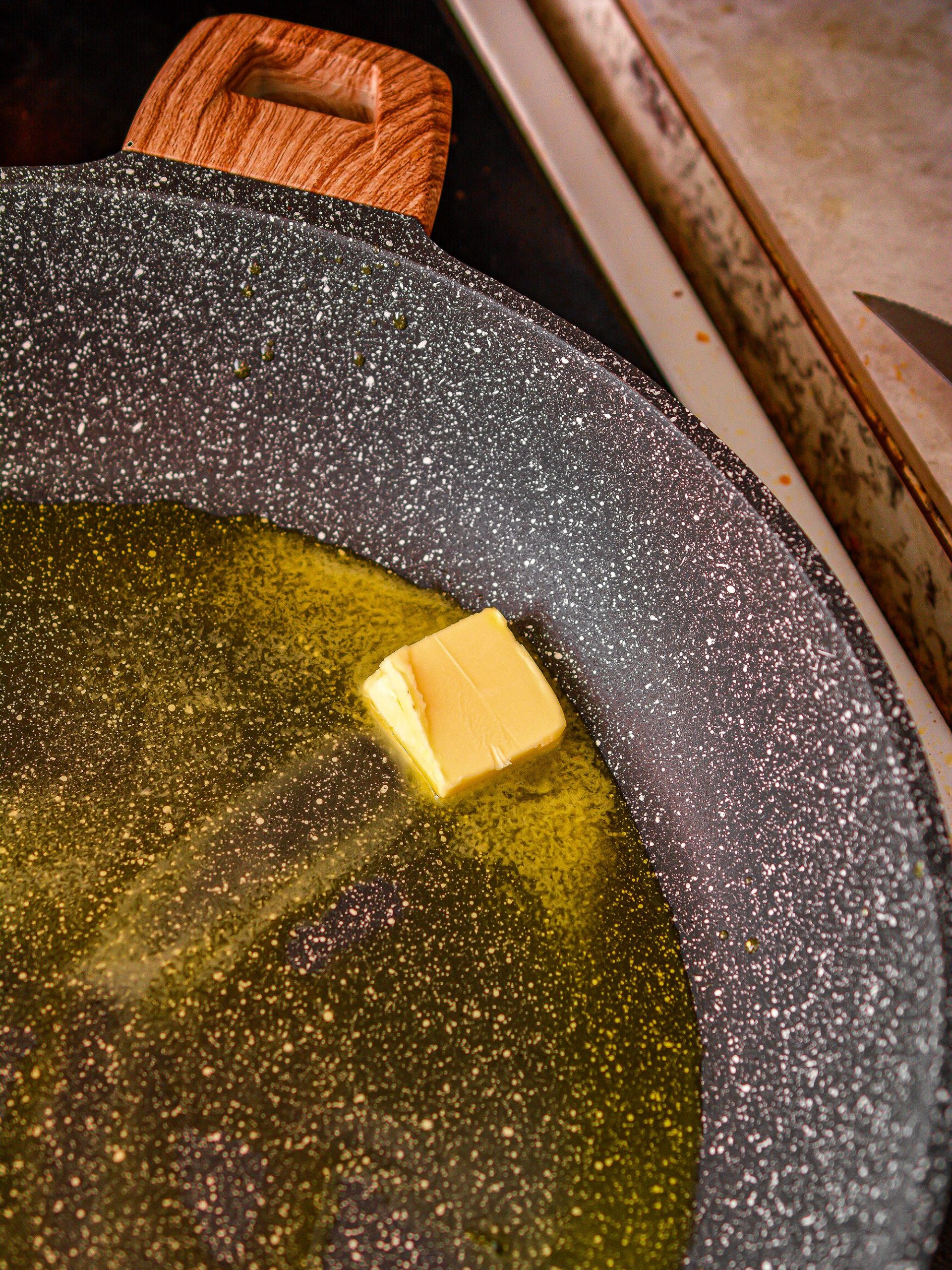 Heat the oil and butter in a skillet over medium high heat.