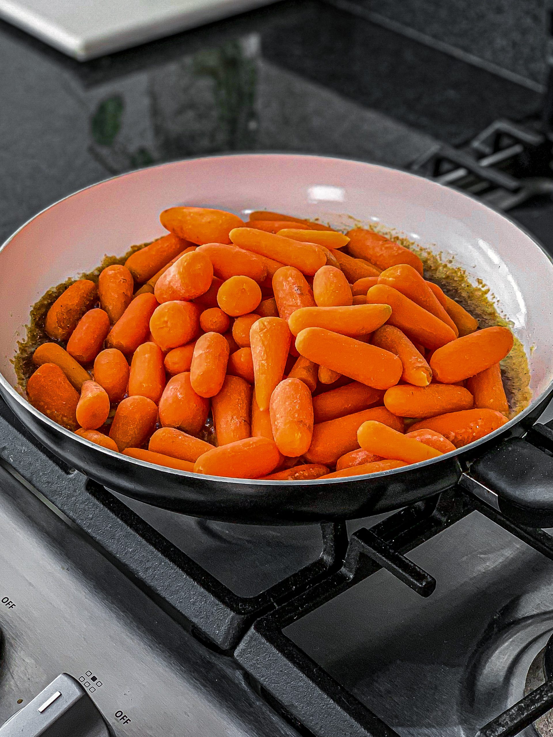 When the glaze is bubbling, add the carrots in the saucepan and toss until well coated.
