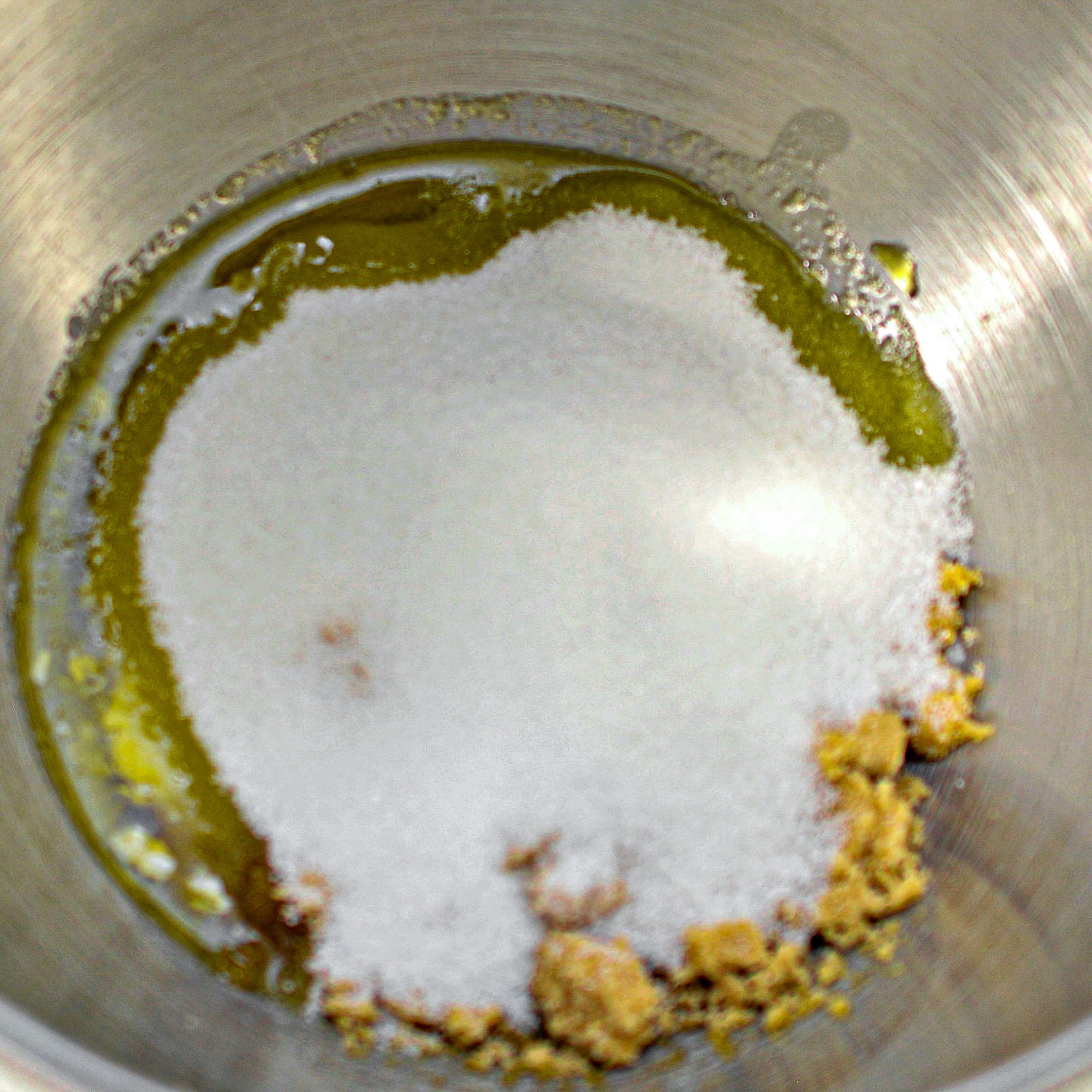 In a mixing bowl, beat together the butter, oil, and sugars until well combined and fluffy.
