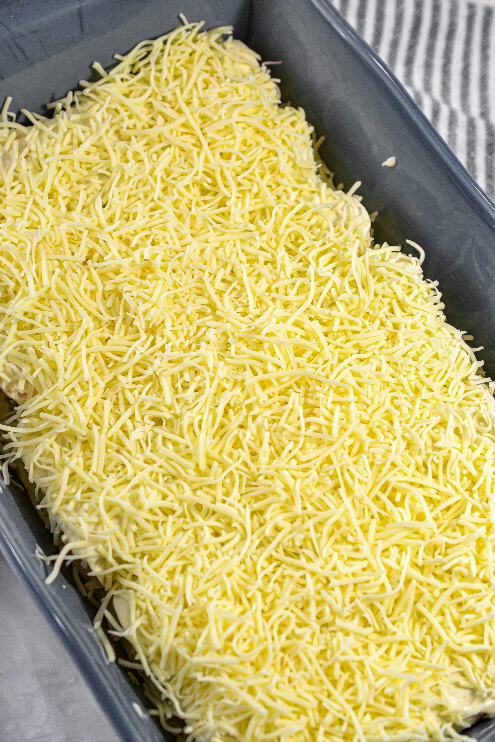Top the enchiladas with the remaining sour cream sauce and sprinkle with the other half of the cheese.