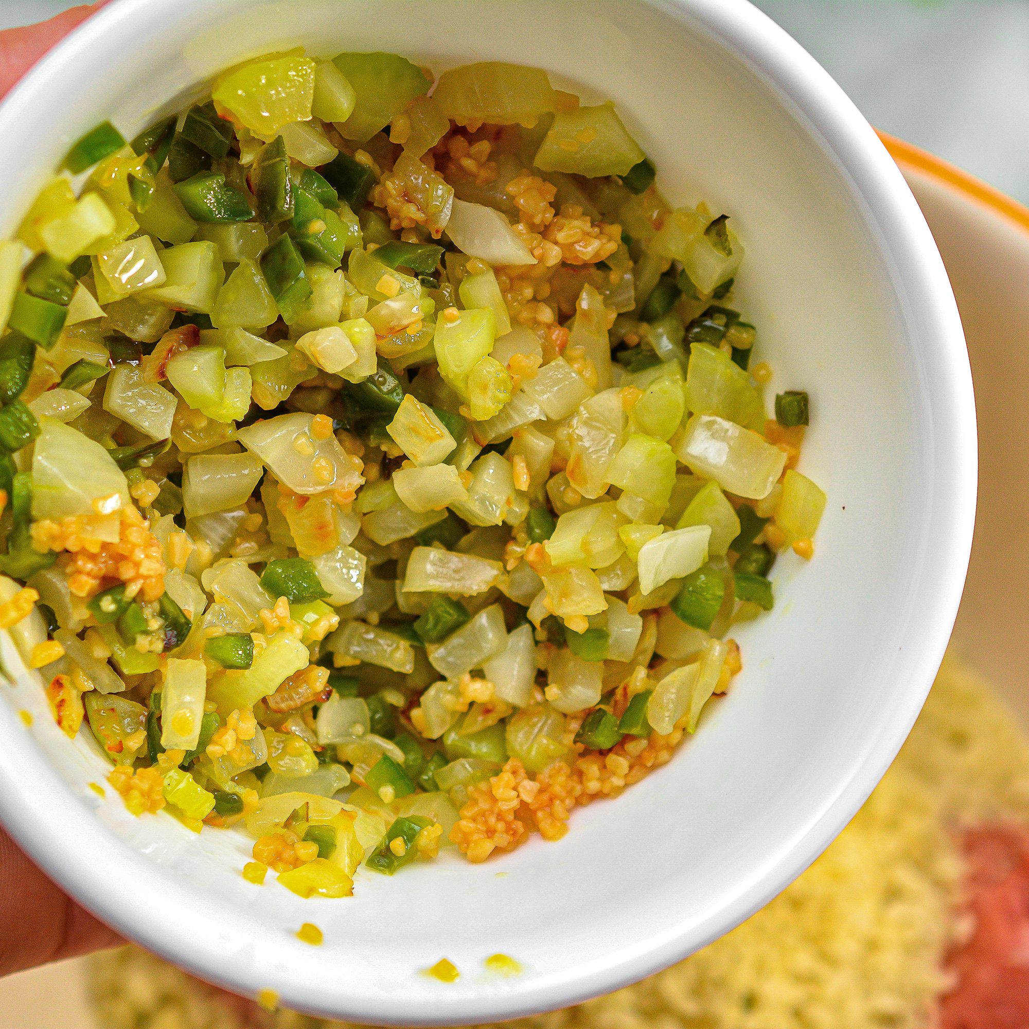 Add the cooled vegetables to a large mixing bowl with the ground turkey, cajun seasoning, 1 Tbsp chili flakes, chopped parsley, large egg, panko crumbs and salt and pepper to taste.