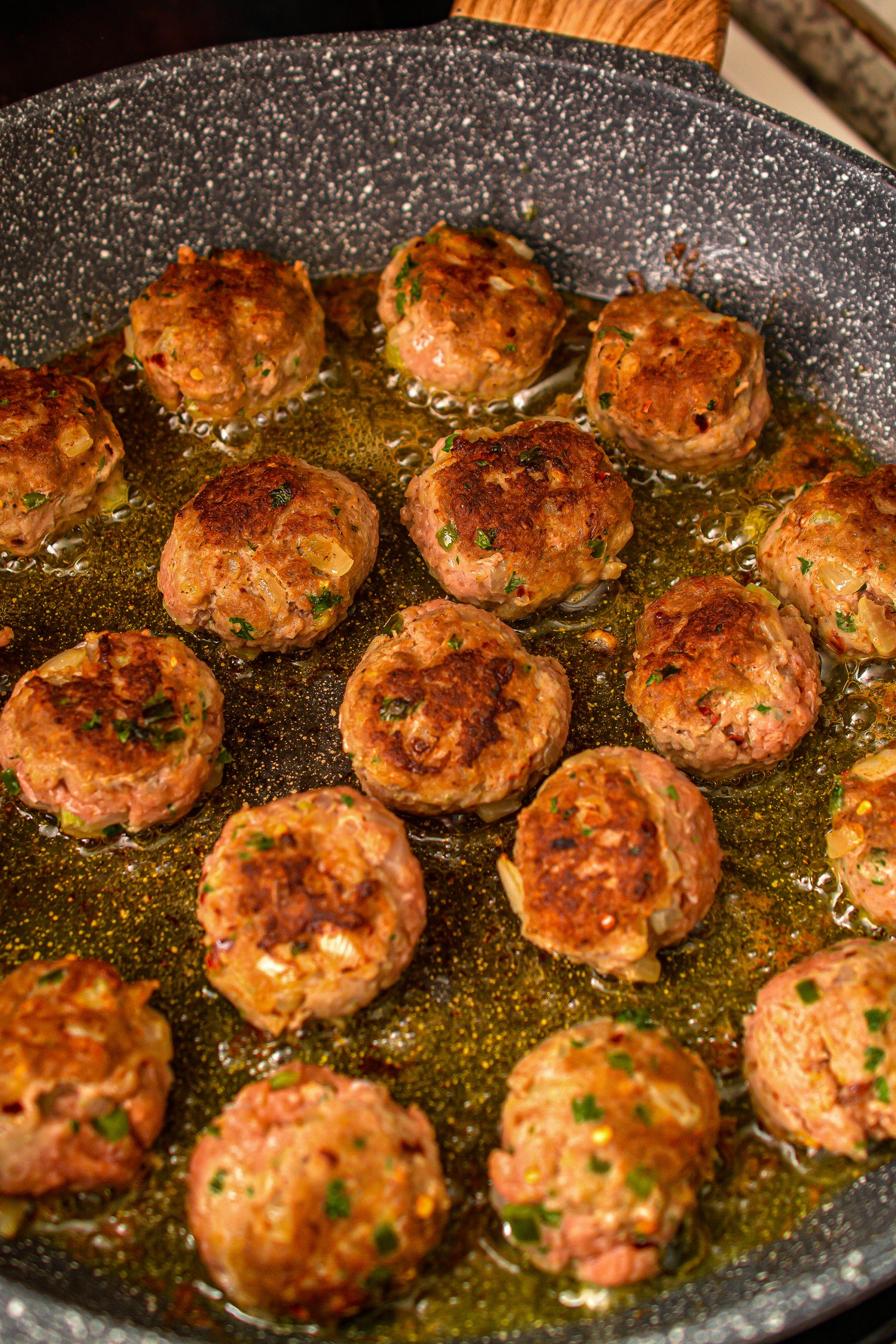 Heat the remaining oil in a skillet over medium high heat and brown the meatballs evenly on all sides.