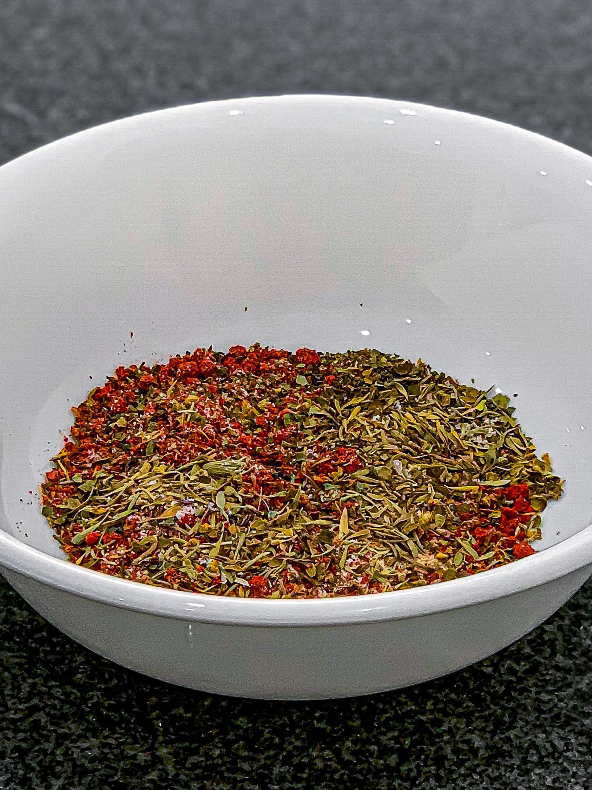 Add dried basil, dried thyme, dried oregano, paprika, onion powder, salt, and pepper in a small bowl and mix well.