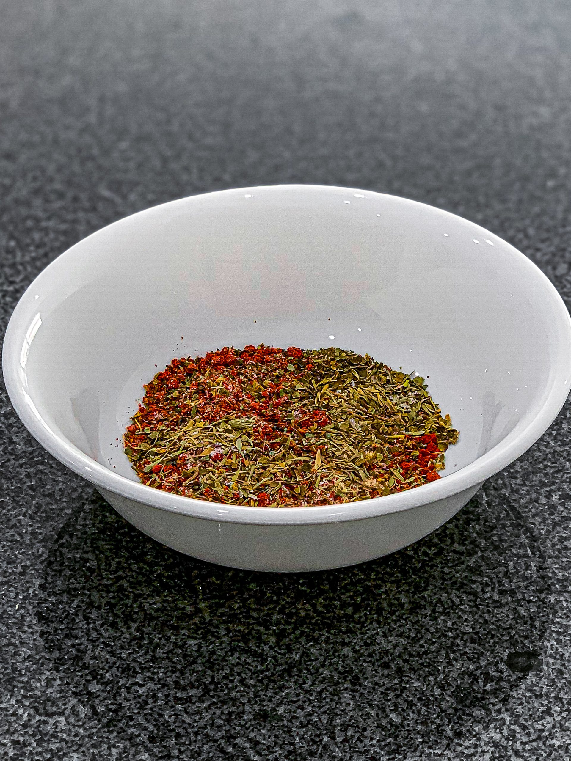 Add dried basil, dried thyme, dried oregano, paprika, onion powder, salt, and pepper in a small bowl and mix well.