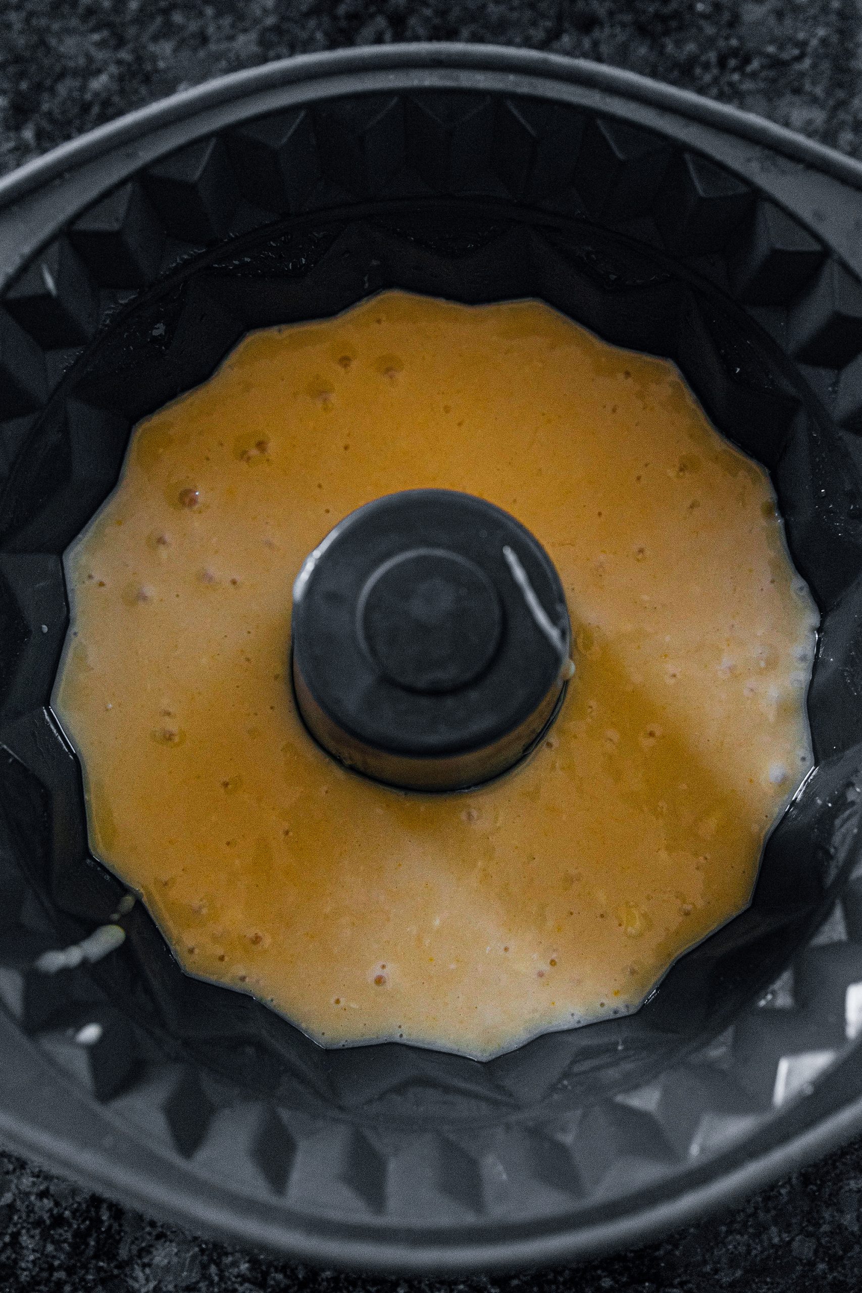Grease a Bundt pan with butter and pour in the mixture.