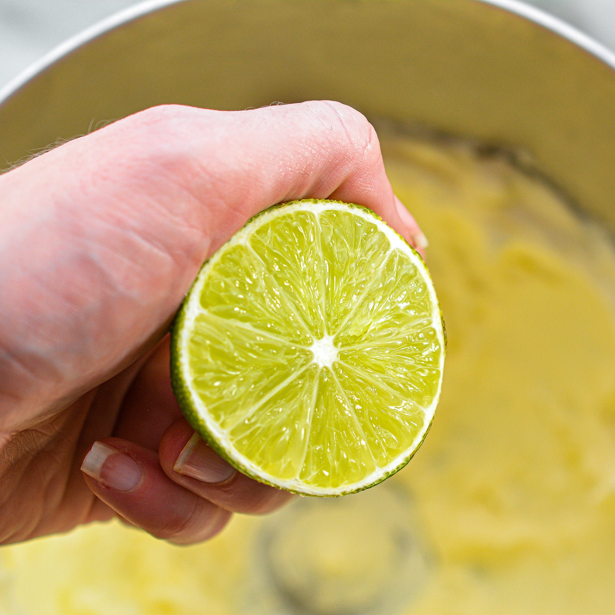 Place the lime juice, zest, and confectioners sugar for the icing to the mixing bowl, and beat until a smooth and creamy icing has formed.