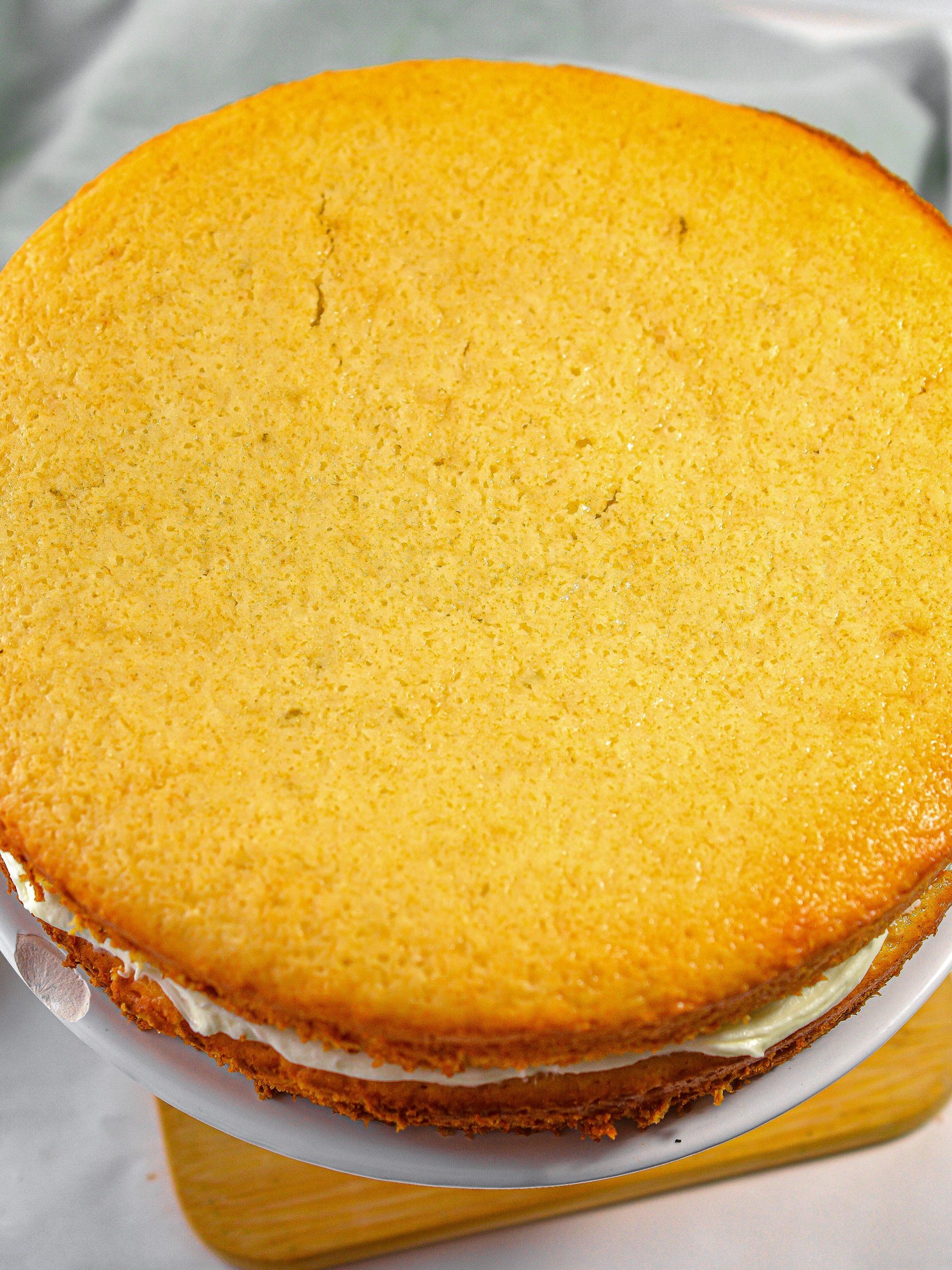 Put the other layer of cake on top of the first, and continue to ice the top and sides of the cake completely.