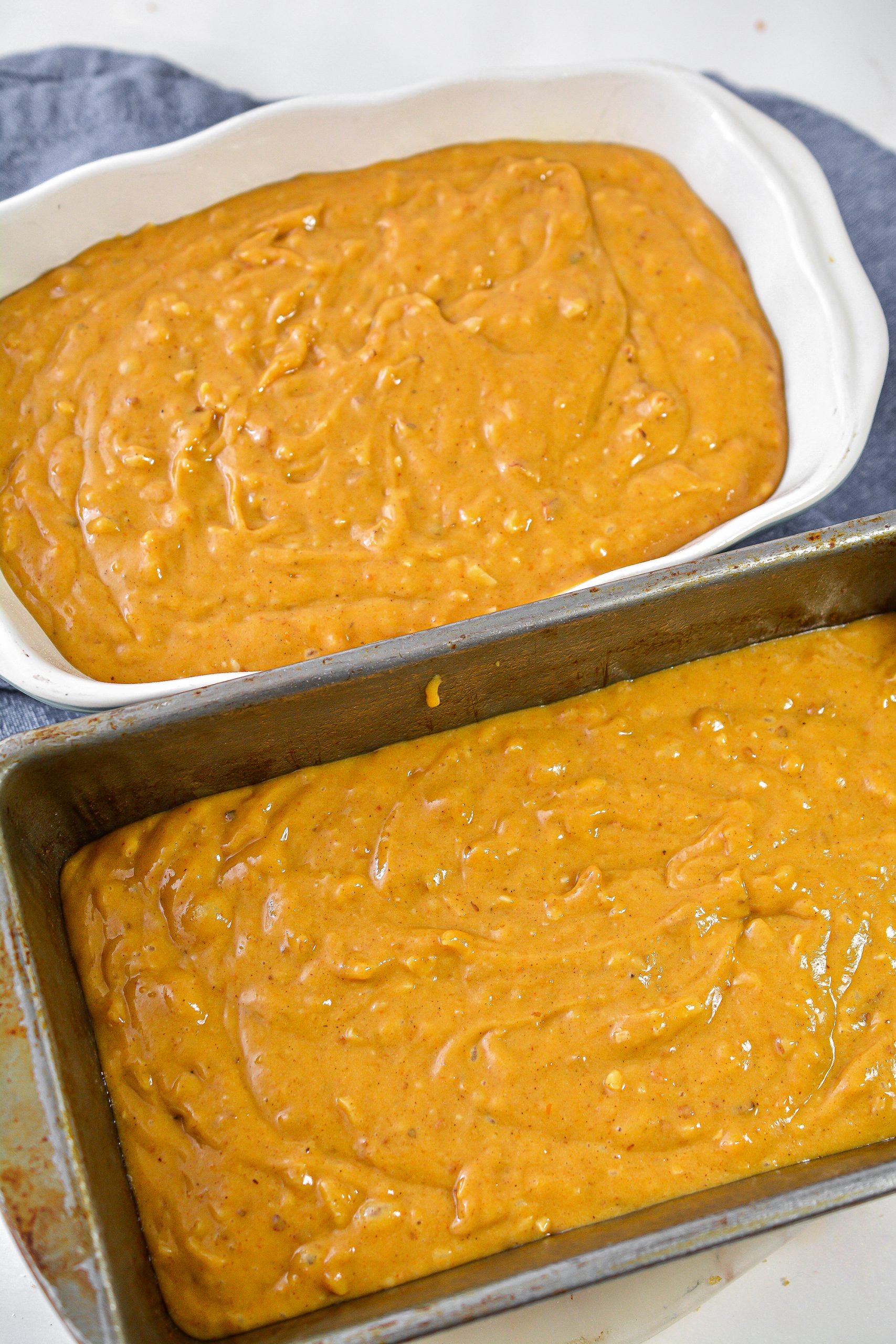 Pour the batter evenly into two well-greased loaf pans.