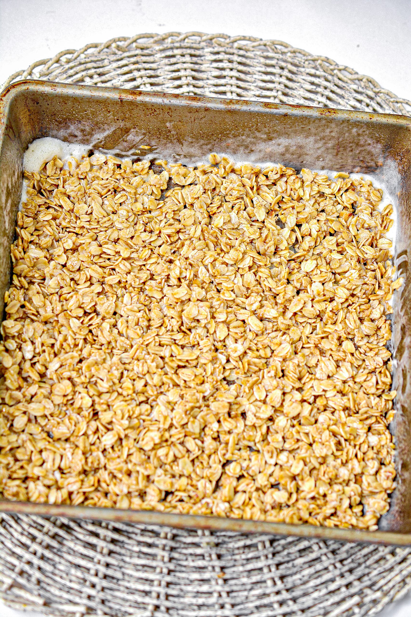 Layer half of the oat mixture in the bottom of a well-greased 9x9 baking dish.