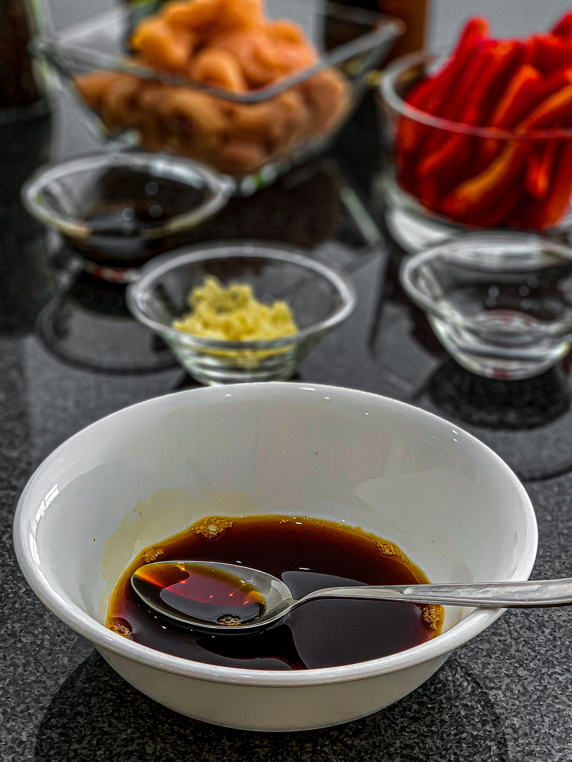 In a medium-sized bowl whisk together half of the soy sauce (1 ½ tbsp), half of the vinegar (1 ½ tbsp), and the honey.